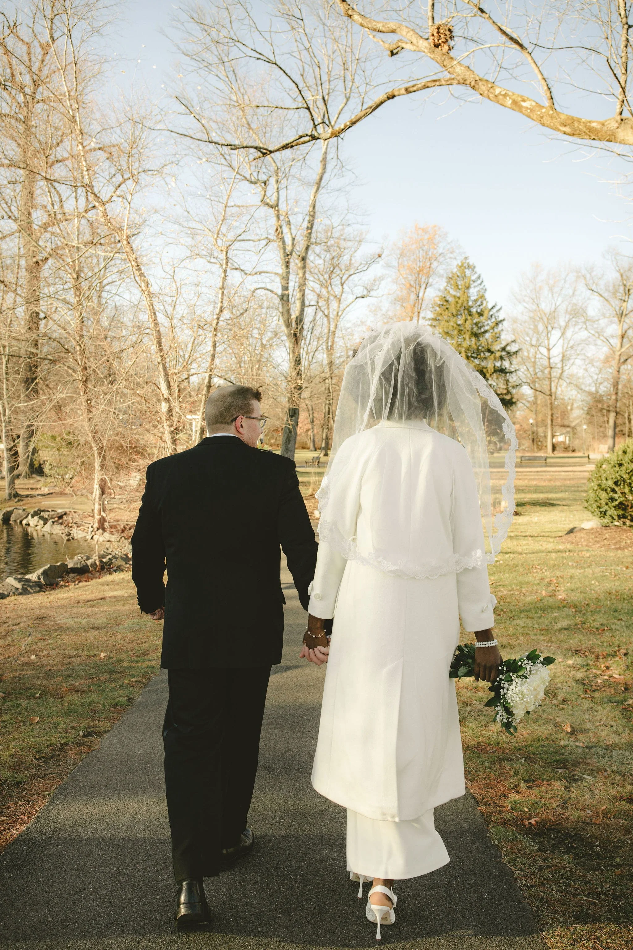 Already married couple walking together before their New Jersey wedding celebration.