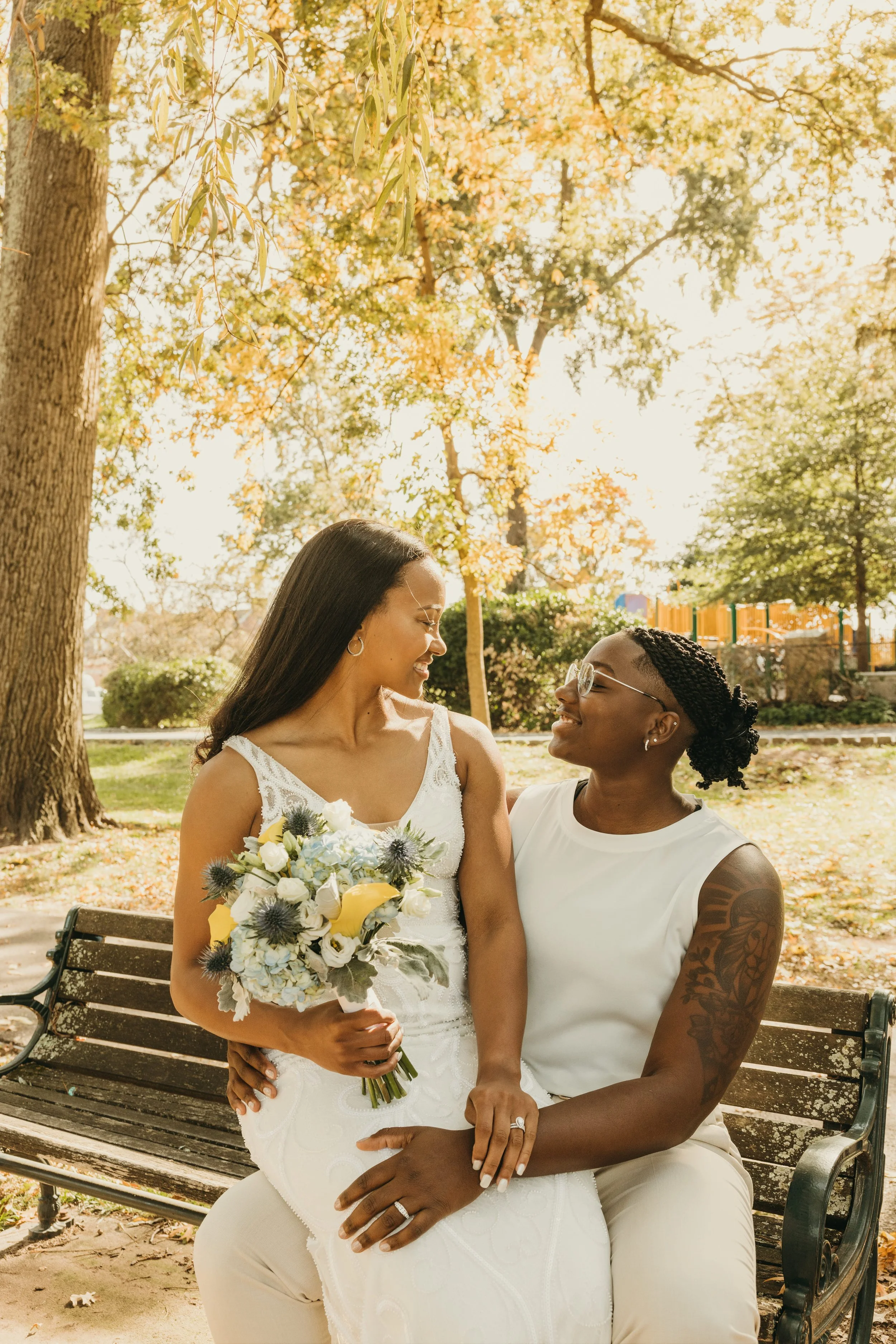 Jaide and Amiaya sharing a quiet newlywed moment on a park bench after their elopement at Mindowaskin Park in Westfield, NJ.