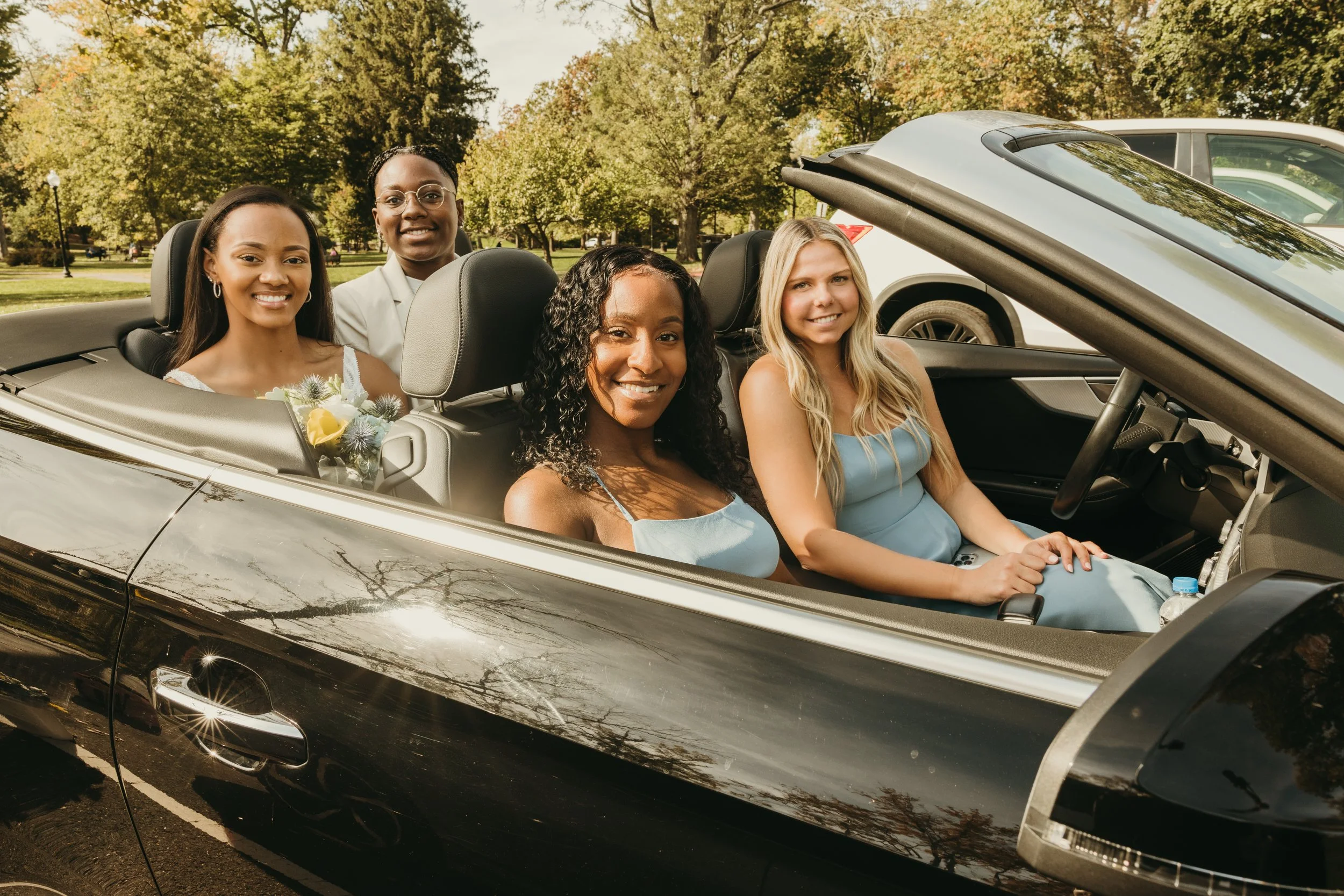 Jaide and Amiaya smile with their two friends in a convertible after their New Jersey elopement ceremony.