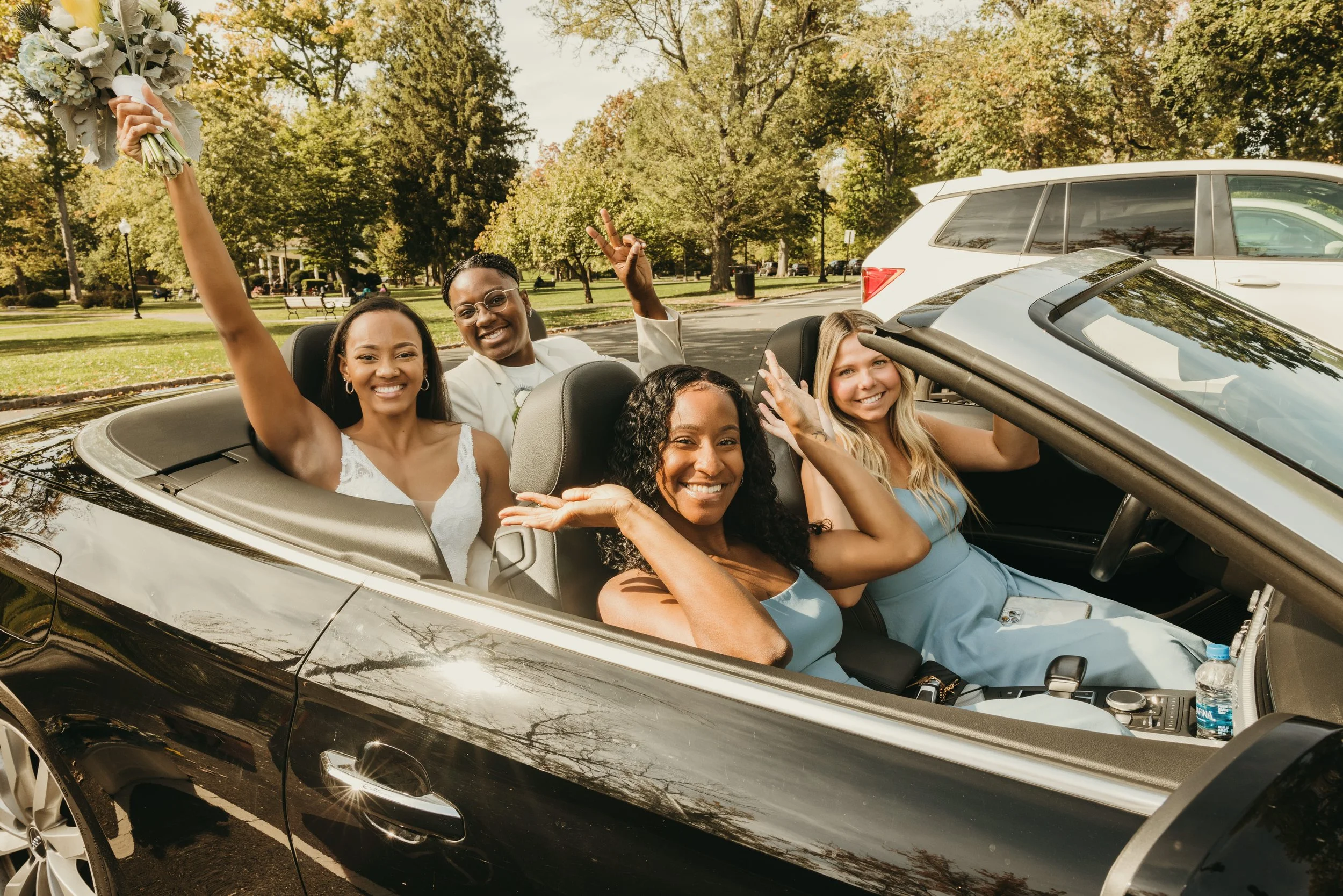Jaide and Amiaya celebrate with their friends in a convertible after their New Jersey elopement ceremony.