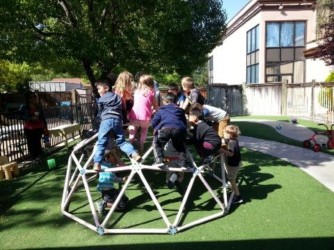 Pictured: Older 3's and 4's enjoying the play equipment