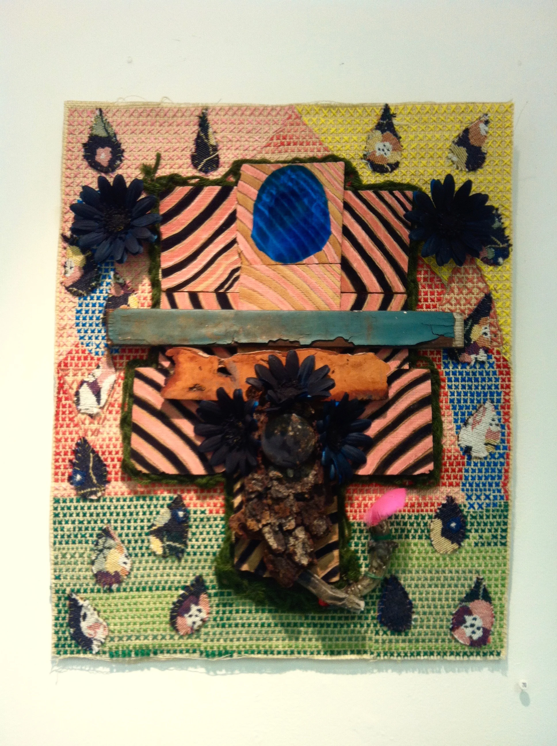 Heathcliff , needlepoint with fabric, found wood, paint, candelabra, nylon flowers, and feather, 12 x 16 inches