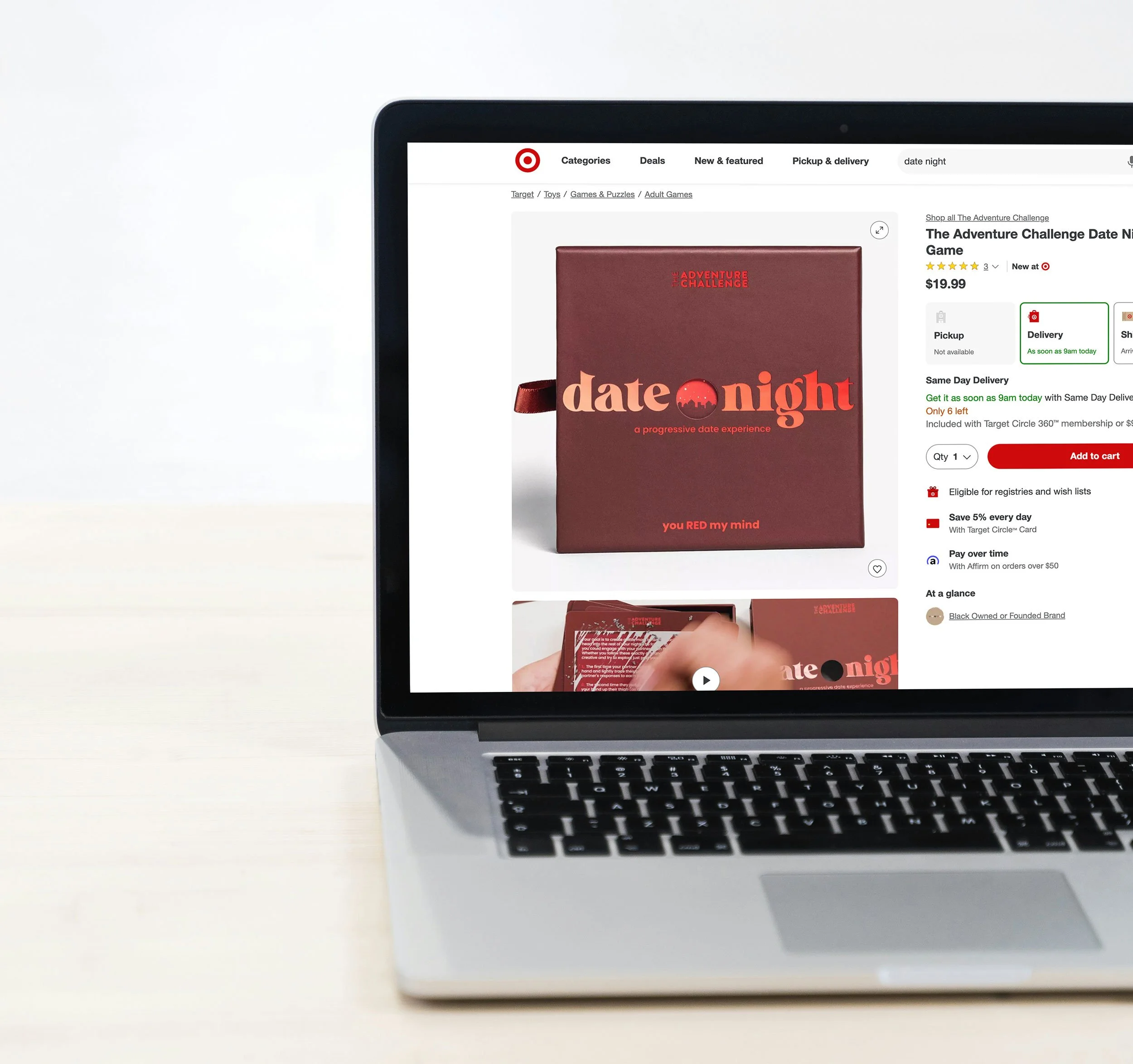 A product box titled Date Night Red Means Go: a progressive date experience sits on a white background product page, on Target.com, on a laptop screen on a laptop sitting on a desk