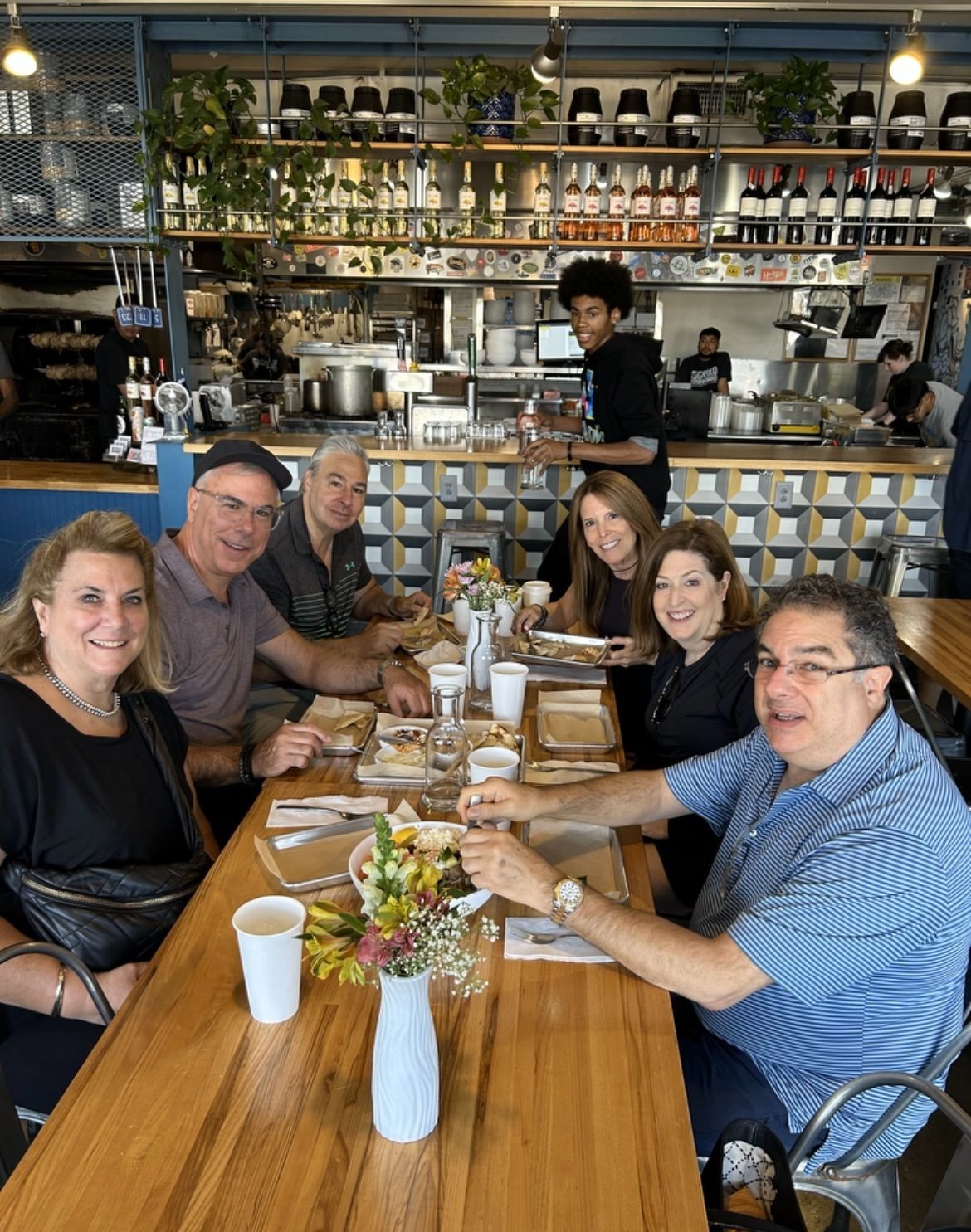 Small group of Walk Eat Nashville food tour guests dining at GreKo Greek Street Food in East Nashville