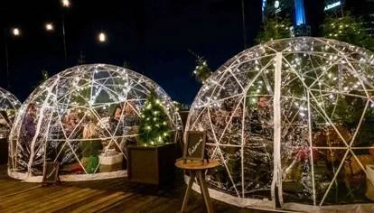 Rooftop holiday igloos and fire pits at Camp Bobby on the Bobby Hotel rooftop in Nashville.