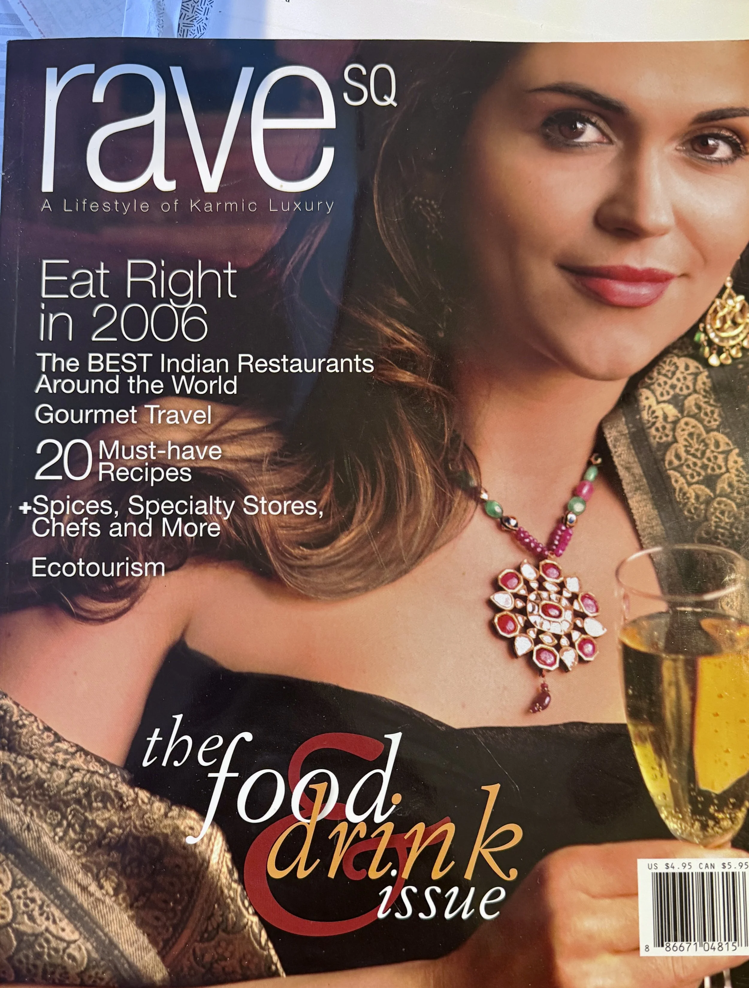 The cover of Rave Singapore magazine featuring a woman in traditional Indian attire holding a glass of white wine, with text about Indian restaurants, recipes, and ecotourism.