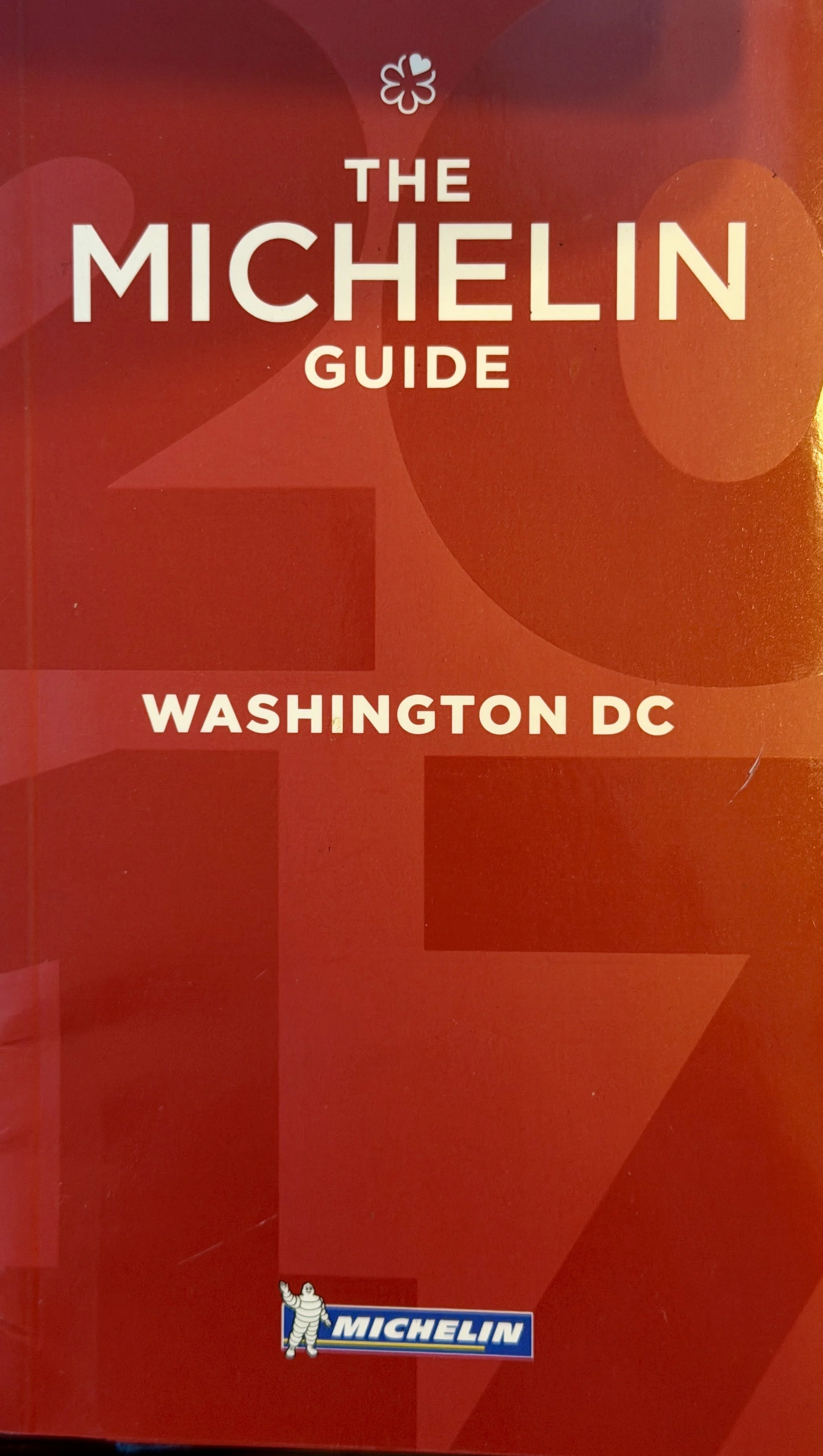 Cover of The Michelin Guide for Washington DC, featuring a red background with the Michelin logo in the bottom left corner.