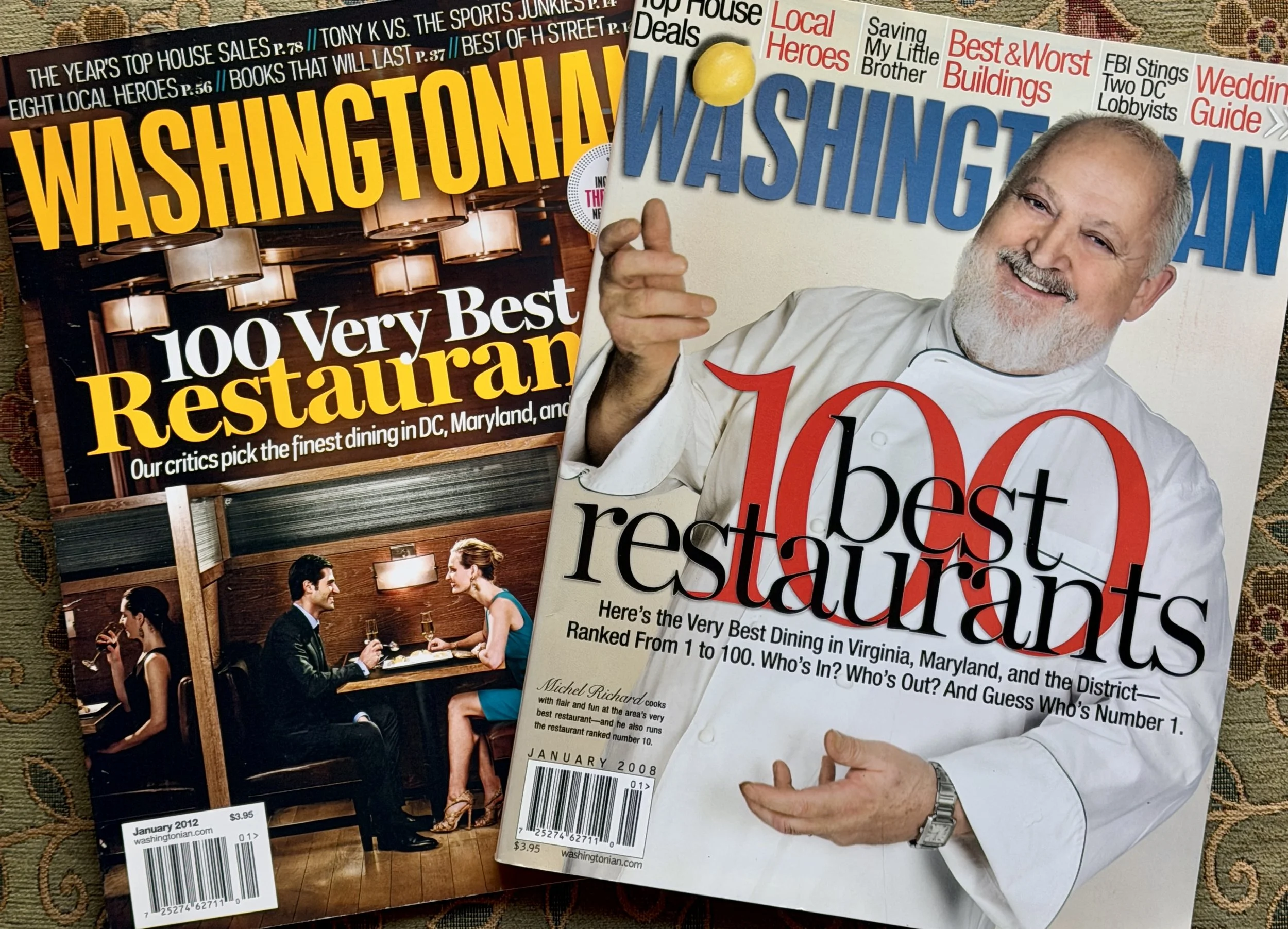 Magazines titled "Washingtonian" and "100 Best Restaurants" with images of a man and a woman dining in a restaurant and a smiling chef, respectively.