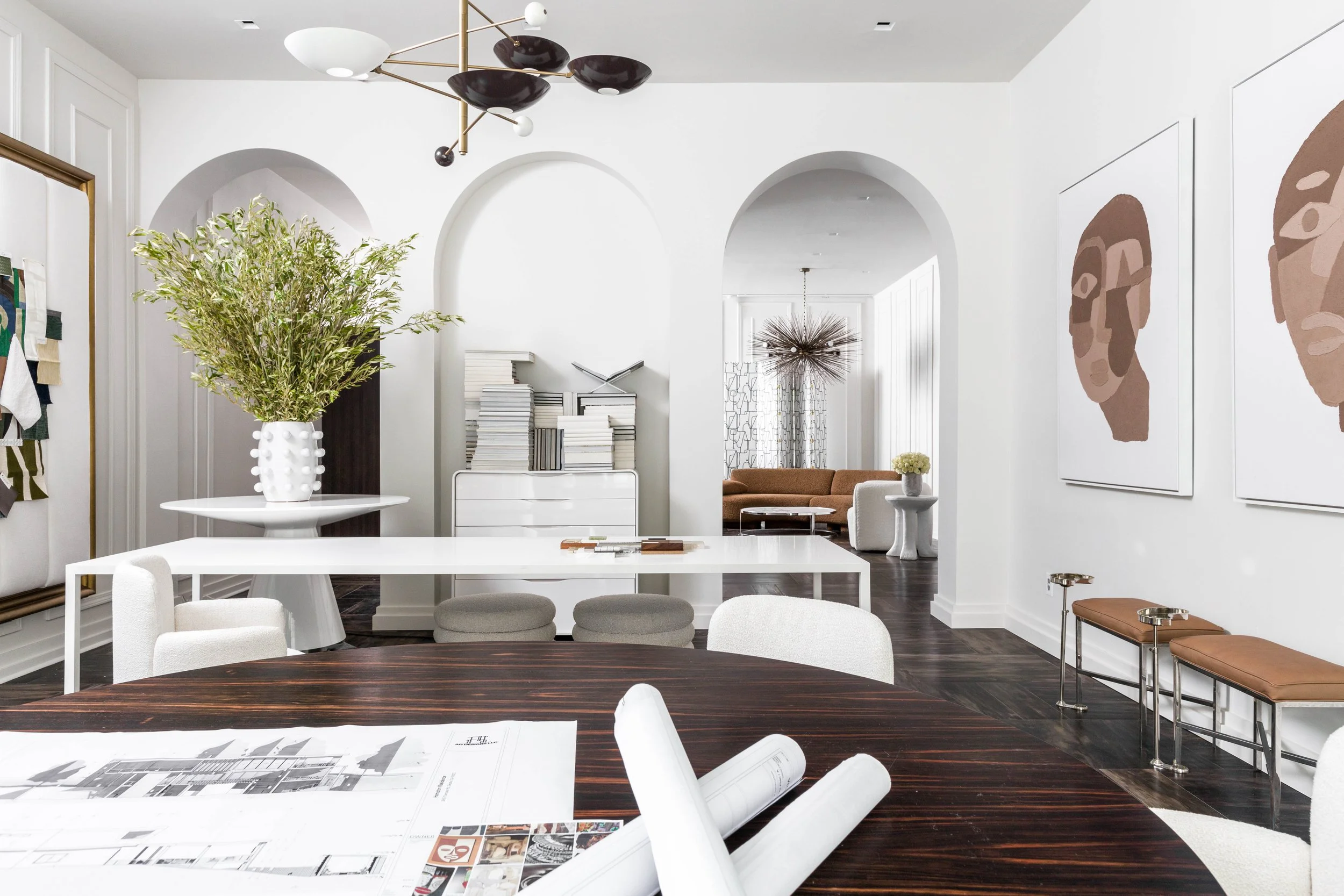 Designer studio with arched openings, sculptural furnishings, and layered modern interiors.
