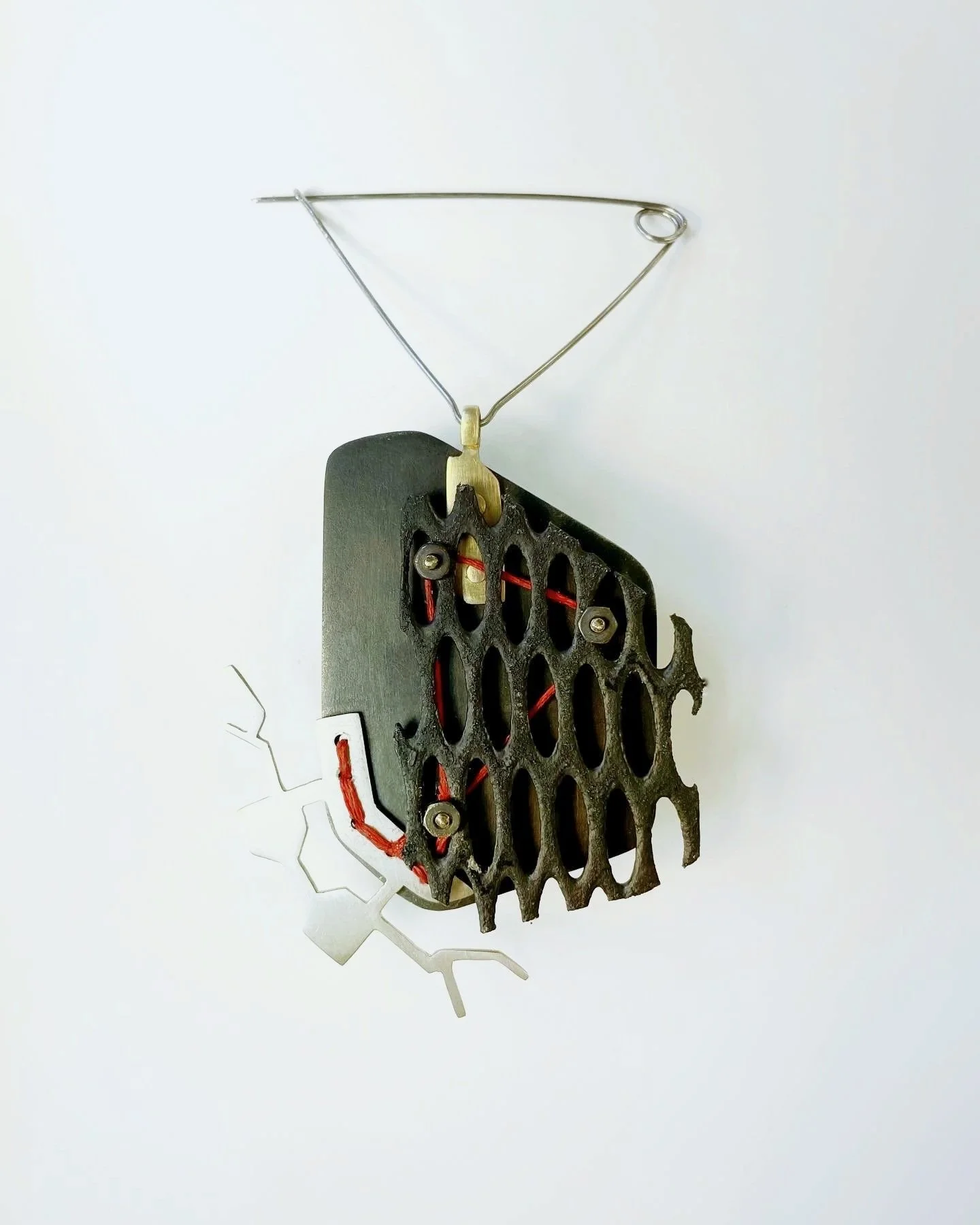 broach: sterling silver, steel, acrylic, string, radiation mask fragment, brass