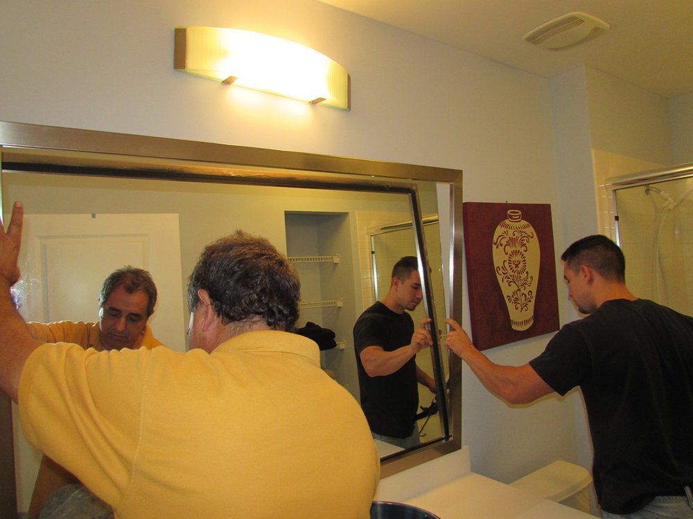 During Captiva Design Installation of Custom Mirror Frame