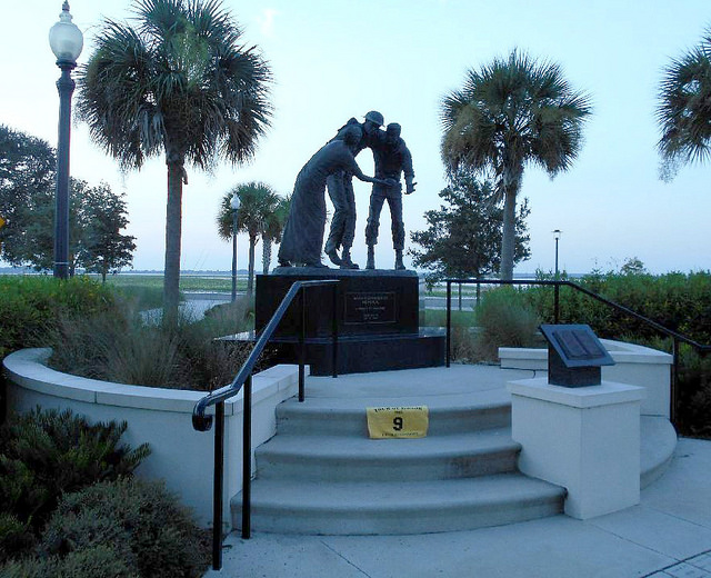 FL4 - Bataan-Corregidor Memorial Kissimmee, Florida Lakefront Park Lakeshore Dr. and Monument Ave. GPS: 28.29047, -81.40307 Access: 24/7, unrestricted Parking is available on the street within picture distance of the statue – but if there is no space available, you can park temporarily at the pedestrian crossover for a photo of the back of the memorial, and then walk in for another photo from the front if you like. The walkways to the memorial are ADA compliant. Take a photo similar to the one above, along with rider flag and motorcycle. Refer to RULES 5-7 ( http://www.tourofhonor.com/pages/rules.html#rules57 ) for photo verification. Scorers have final say whether standards are met. More.... A poignant memory of the siege of Bataan and Corregidor. Gen. Douglas McArthur and his forces had retreated to the Philippine island of Corregidor and the Bataan Peninsula. From there, American and Filipino forces battled the Japanese for 99 days without resupply until finally the entire 76,000 man Bataan contingent was forced to surrender. The next day began the infamous Bataan Death March, a grueling 65 miles with no food, water, or rest. Reportedly, 10,300 died during the march and 31,000 died of disease or were executed within 90 days, after reaching prison camps in Luzon. (Orlando Sentinel Article April 8, 1994)