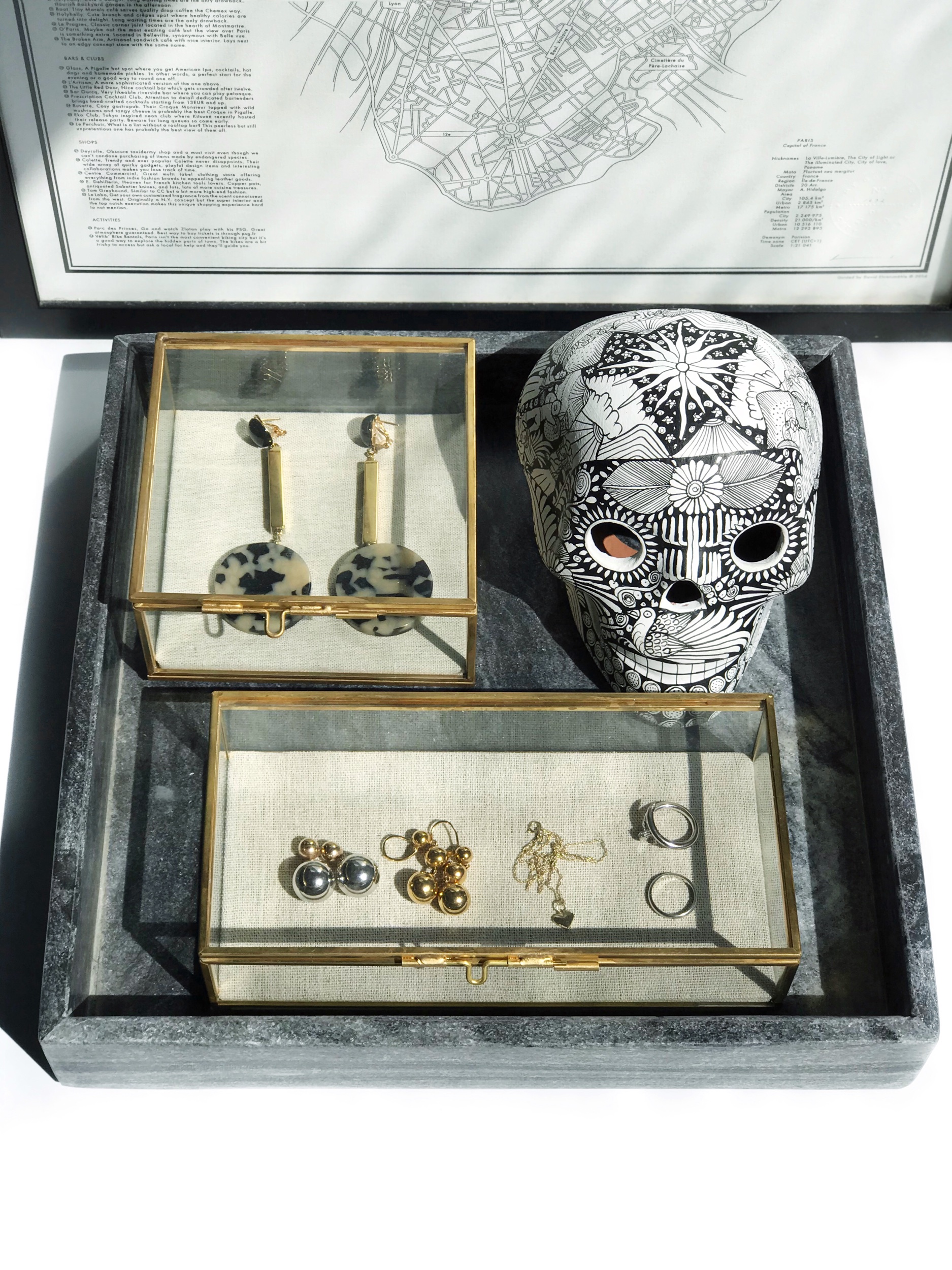 Top: Rachel Comey earrings . Bottom L-R: Céline earrings, Dior earrings , BeauniqJewelry heart pendant and necklace, Cartier rings (not pictured are my Catbird and Mejuri earrings because I never take them off). Skull from Onora , jewelry boxes from West Elm and marble tray from Tenfold by The Line