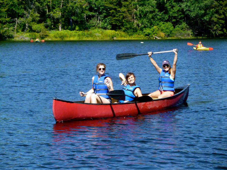 Coral (left) canoeing with camper Ellen and volunteer Lara "Aqua" Gechijian