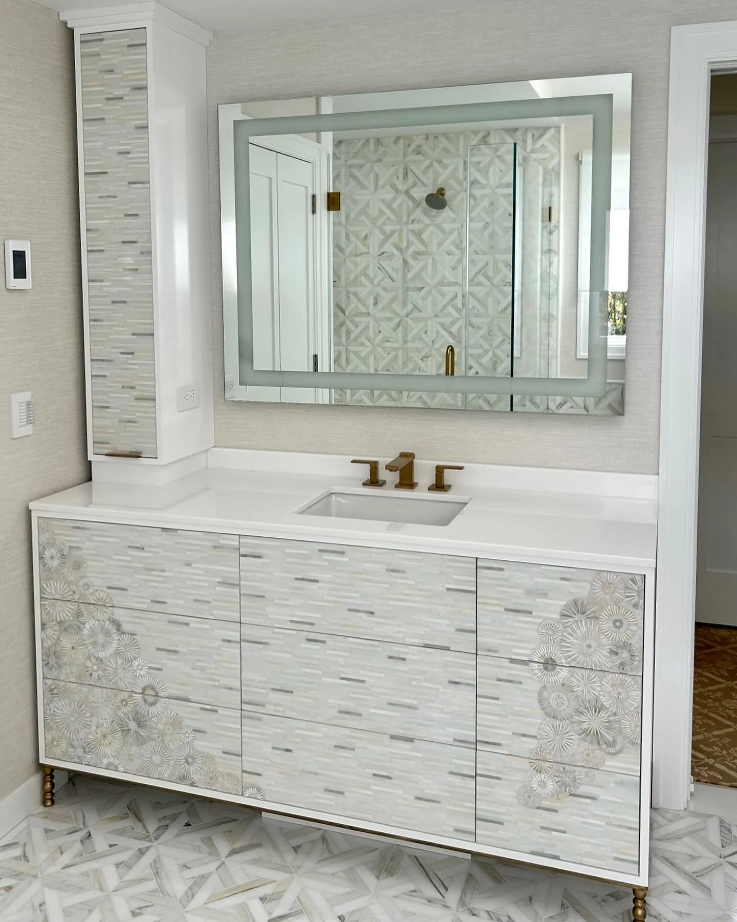 Perfectly paired for balance and beauty ✨ his and hers Vanities and Towers, in white and grey hand-cut glass mosaic stripes and blossoms for the genius @janiebbloom