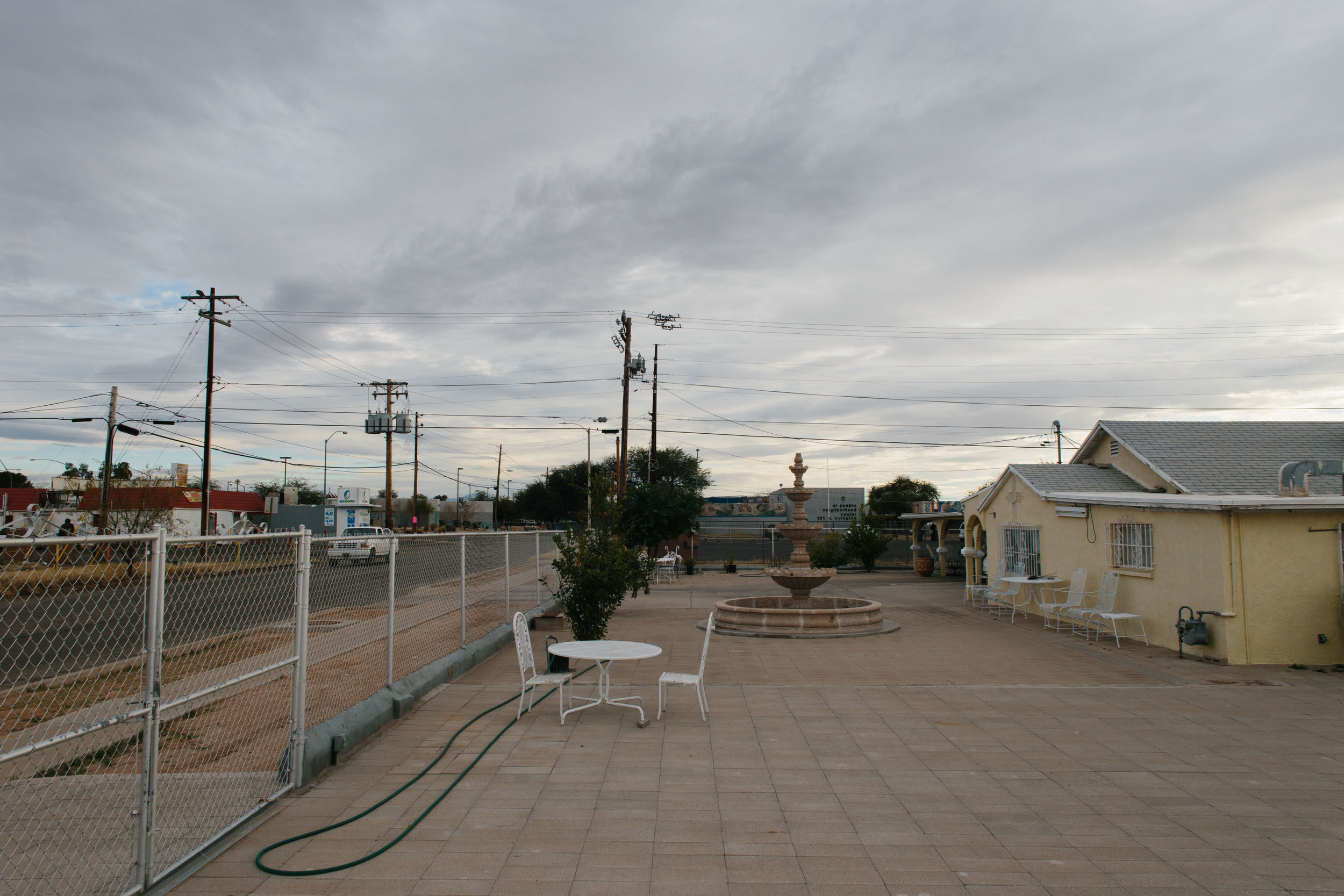 A dry fountain in a paved lot, west of 12th Ave., South Tucson.