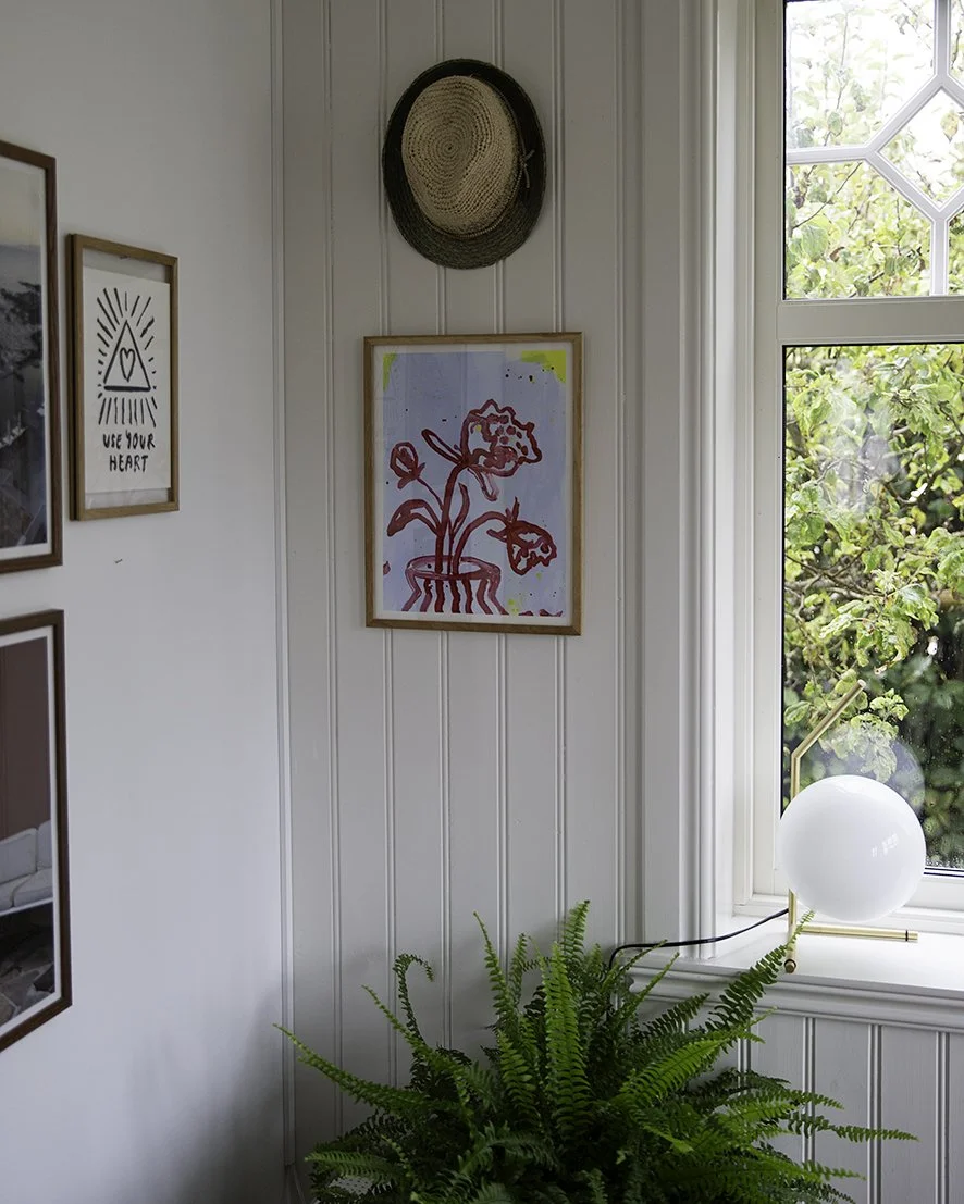 Abstract painting of red flowers hanging in a room