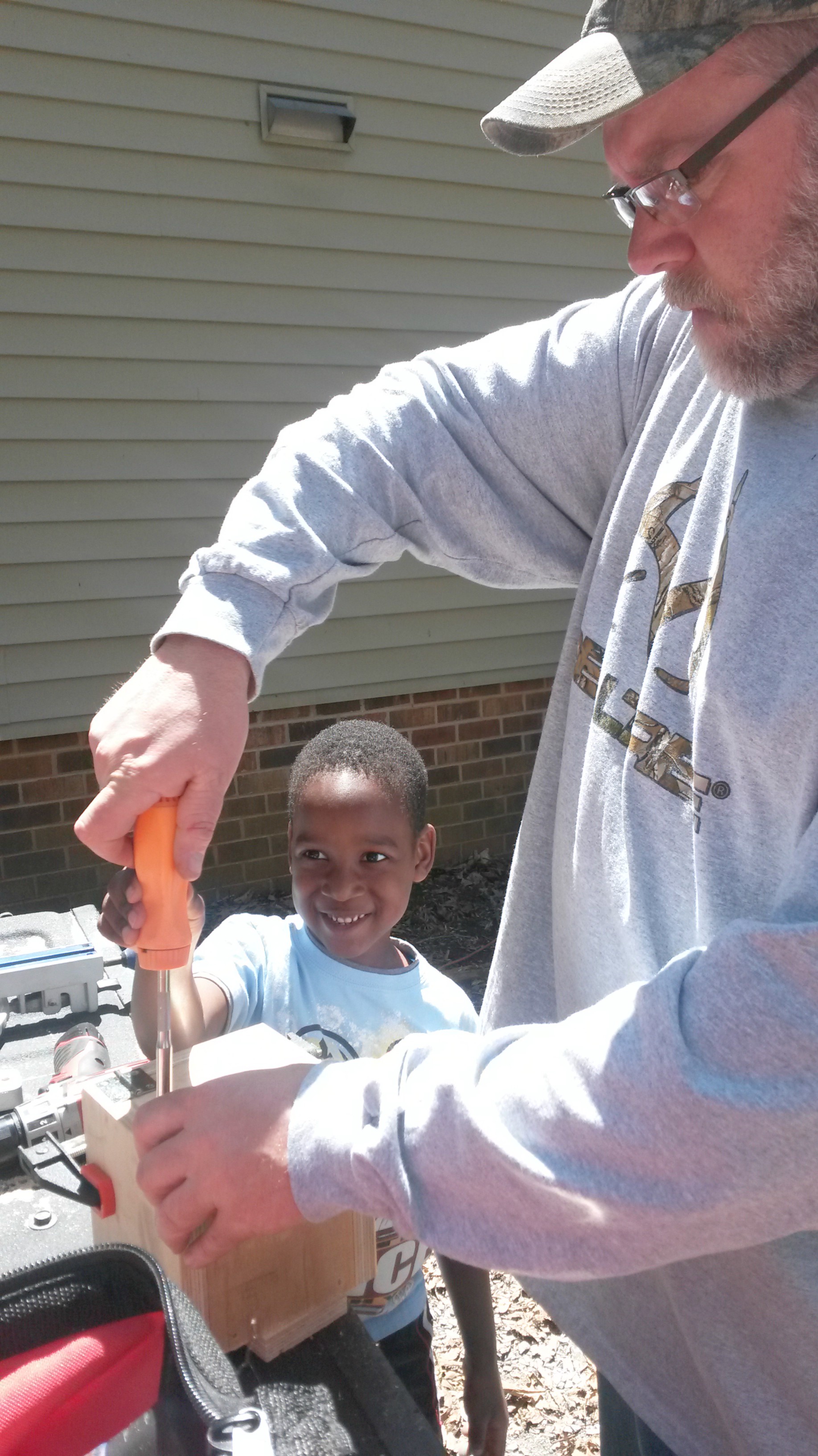 Helping Dad build a box for his money!