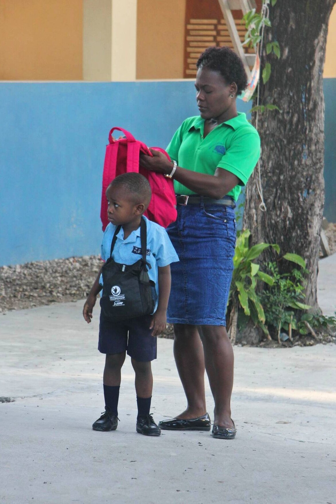 EDIT Teacher helping with backpack.jpg