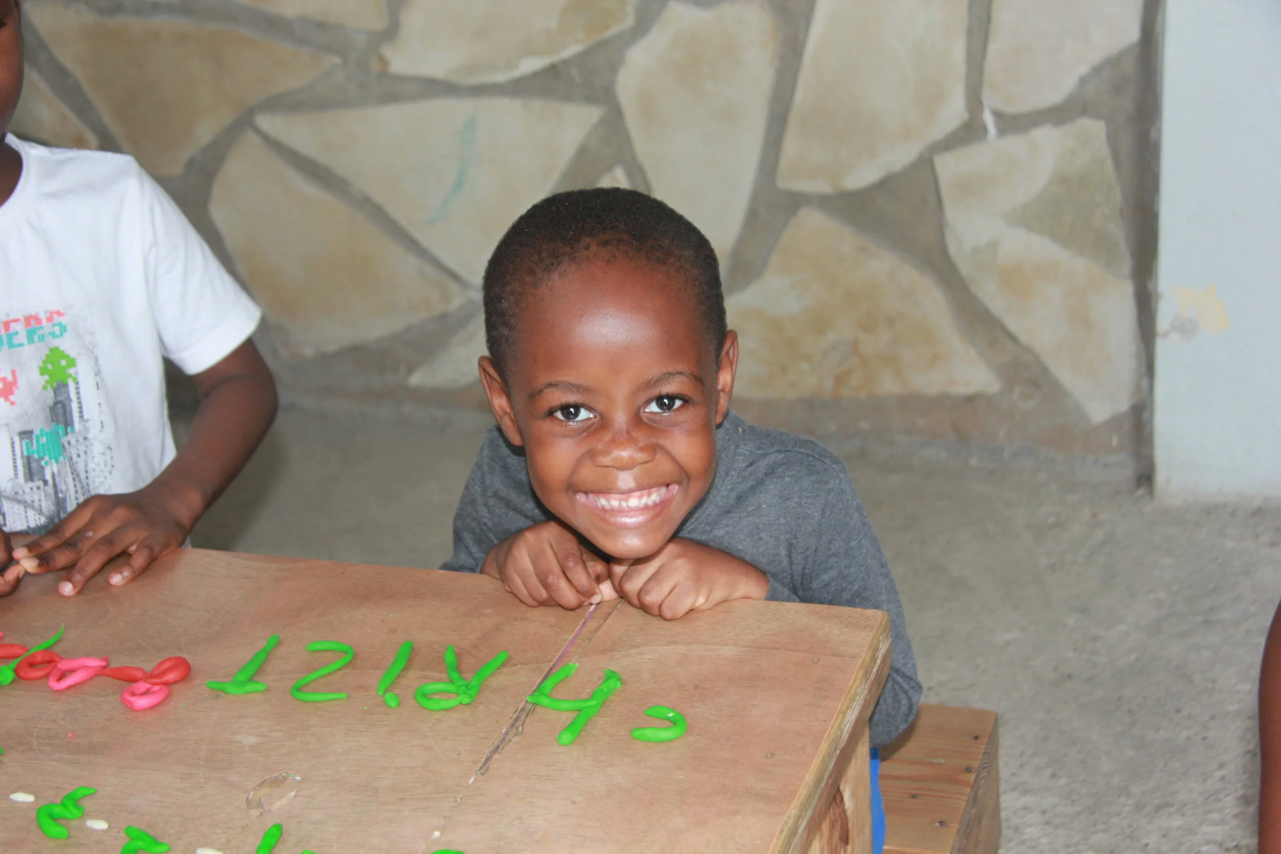  Christ learning to write his name in Angel House’s preschool program 
