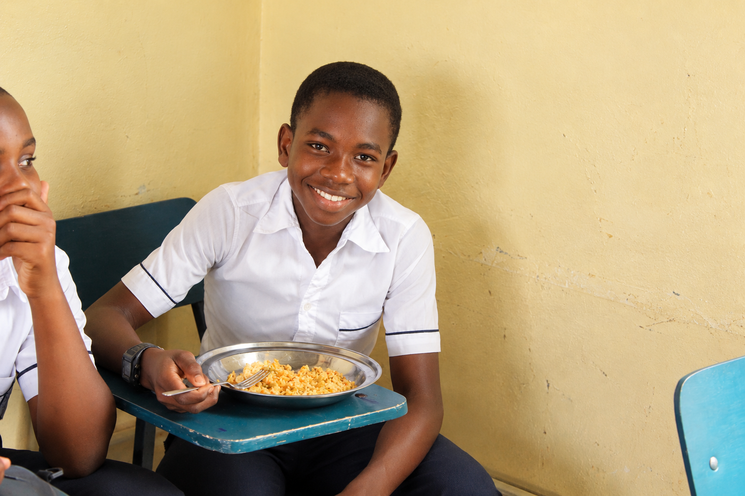 Smiling Student Enjoying School Lunch.png