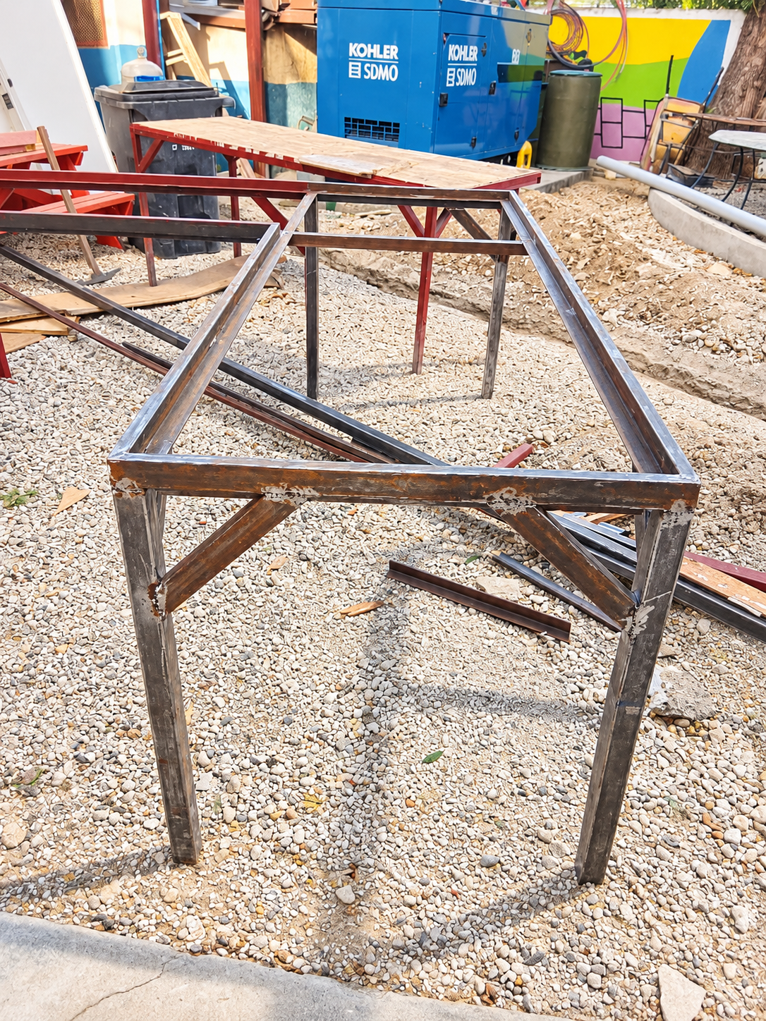 Rusty Steel Table Frame in Workshop Yard.png