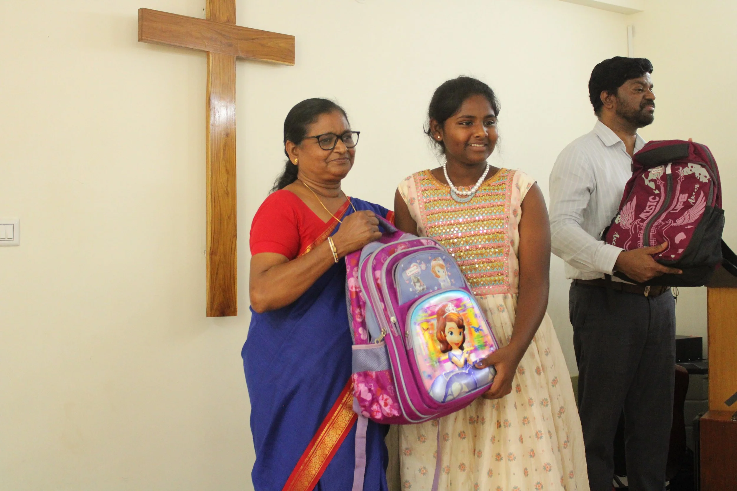 26 - giving study materials to children.jpg