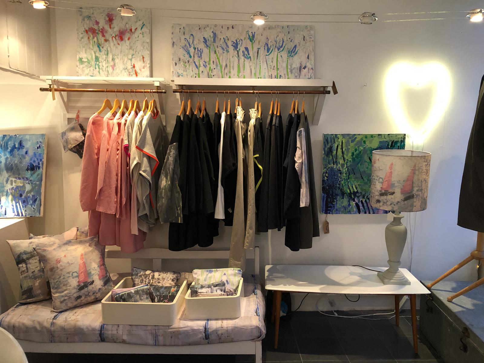 The interior at Betty loves Bryan showcasing paintings, clothes and accessories by Liz Shedden. Paintings from left to right: Blue abstract £300, Floral 1 £300, Joy 11 £300, Green abstract £300, Pink sails lampshade £55, Tunics : £48, Bags from £12, Fabric £35/metre
