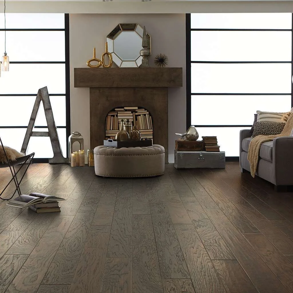 Wide-plank wood flooring in a contemporary living room with a fireplace