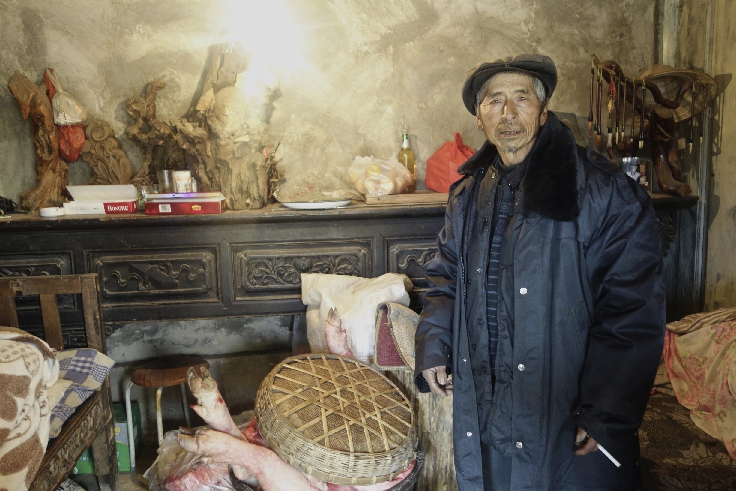 Farmer in his bedroom in a village north of Lijiang