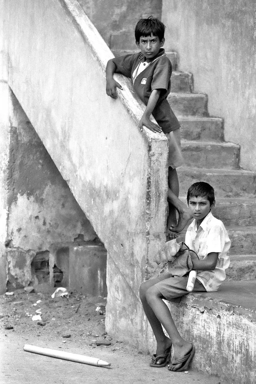 Two cricketers outside a house, Visakhapatnam, April 2001