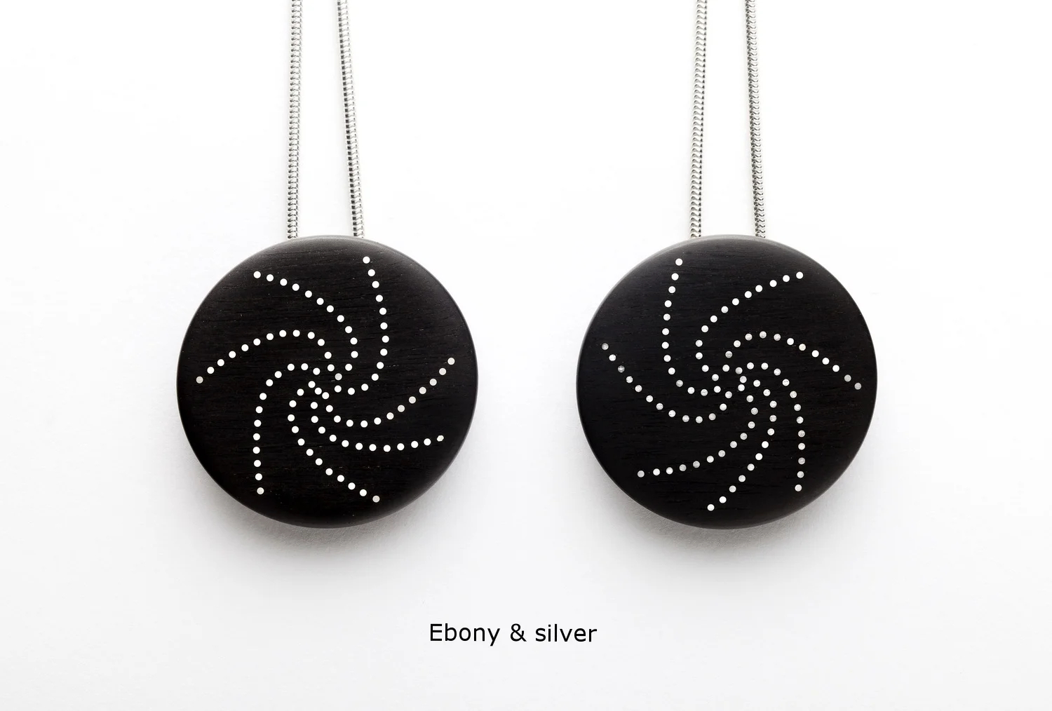 Roger Bennett - Two ebony pendants inlaid with silver