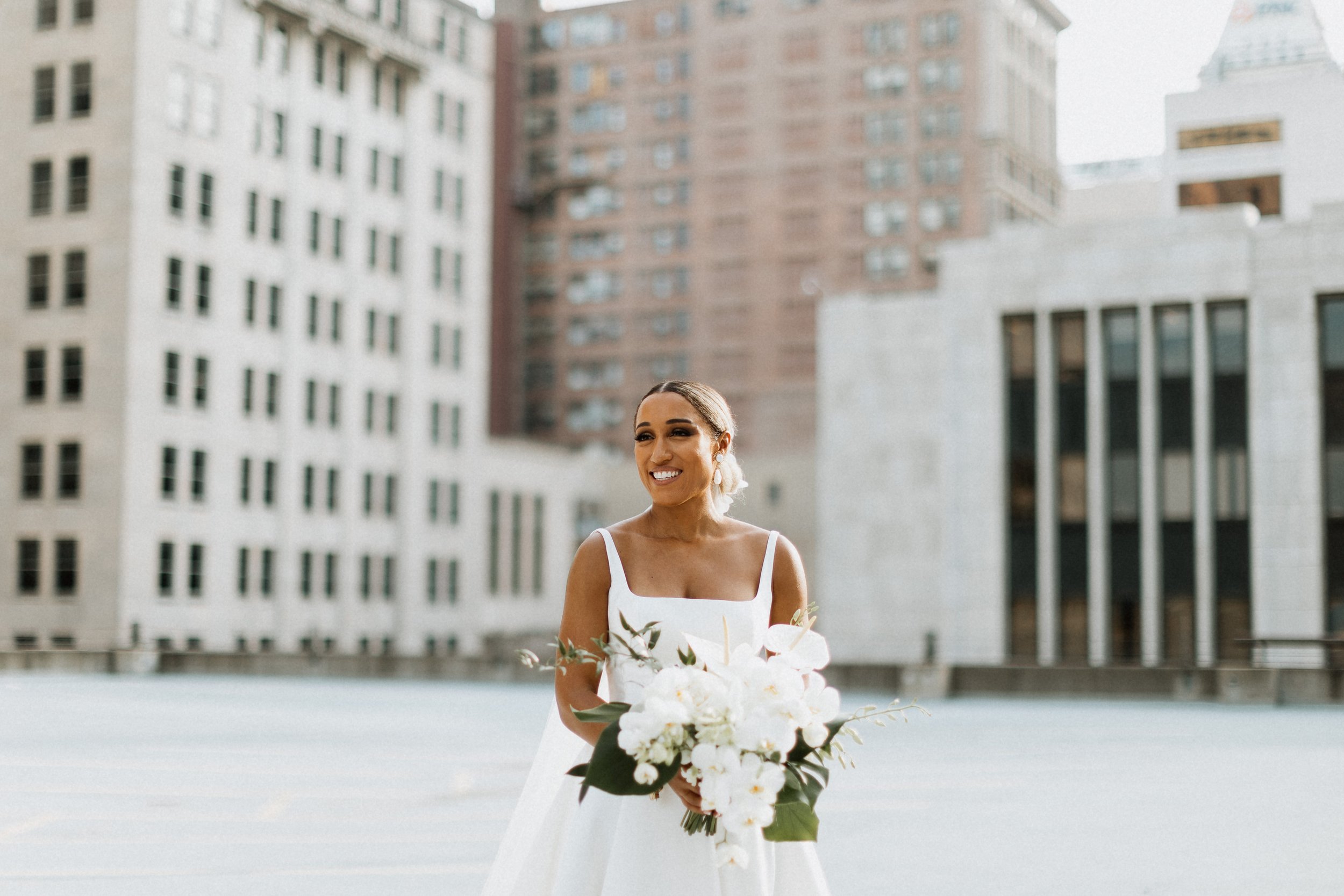 Bride laughing downtown 