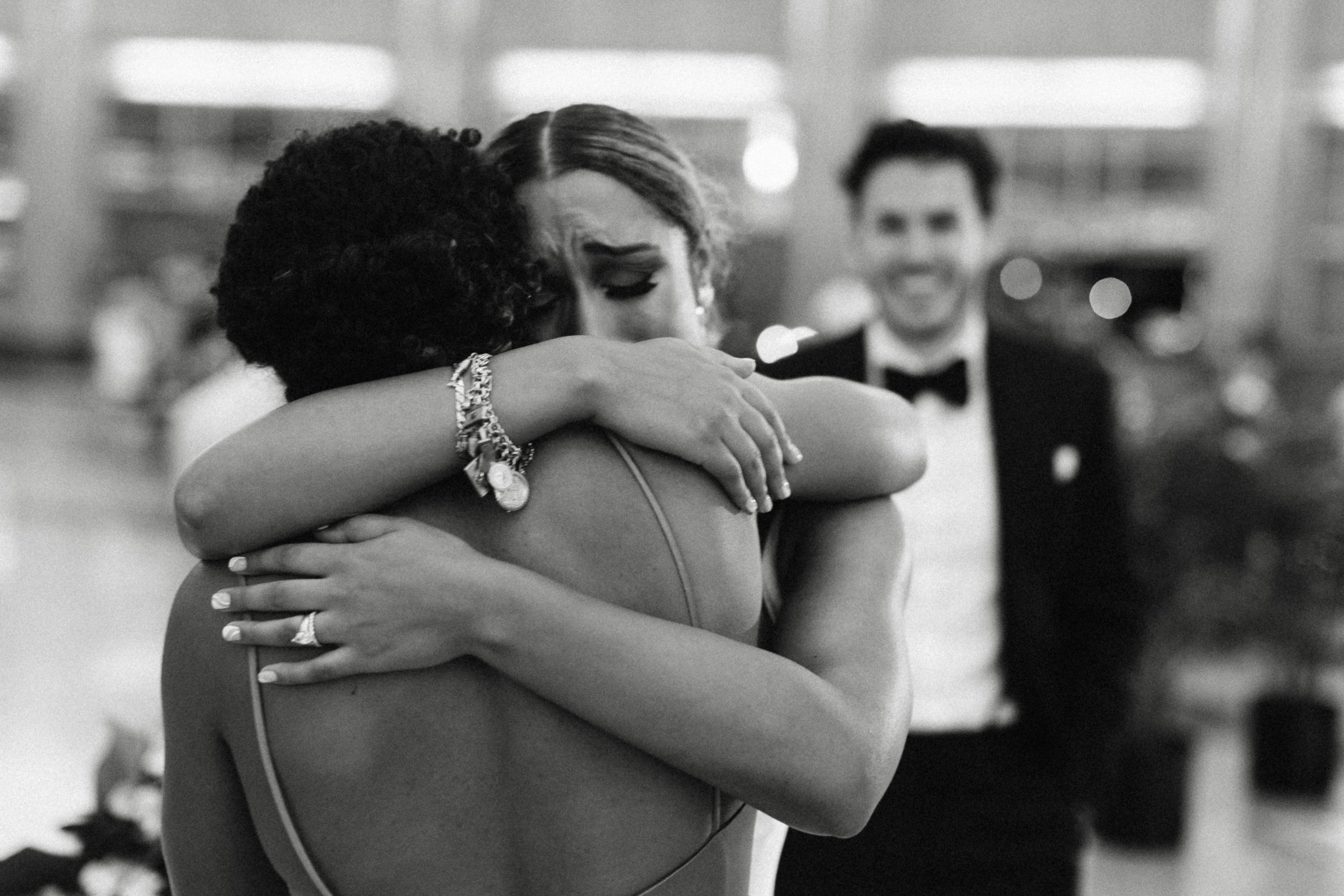 Bride hugging maid of honor 