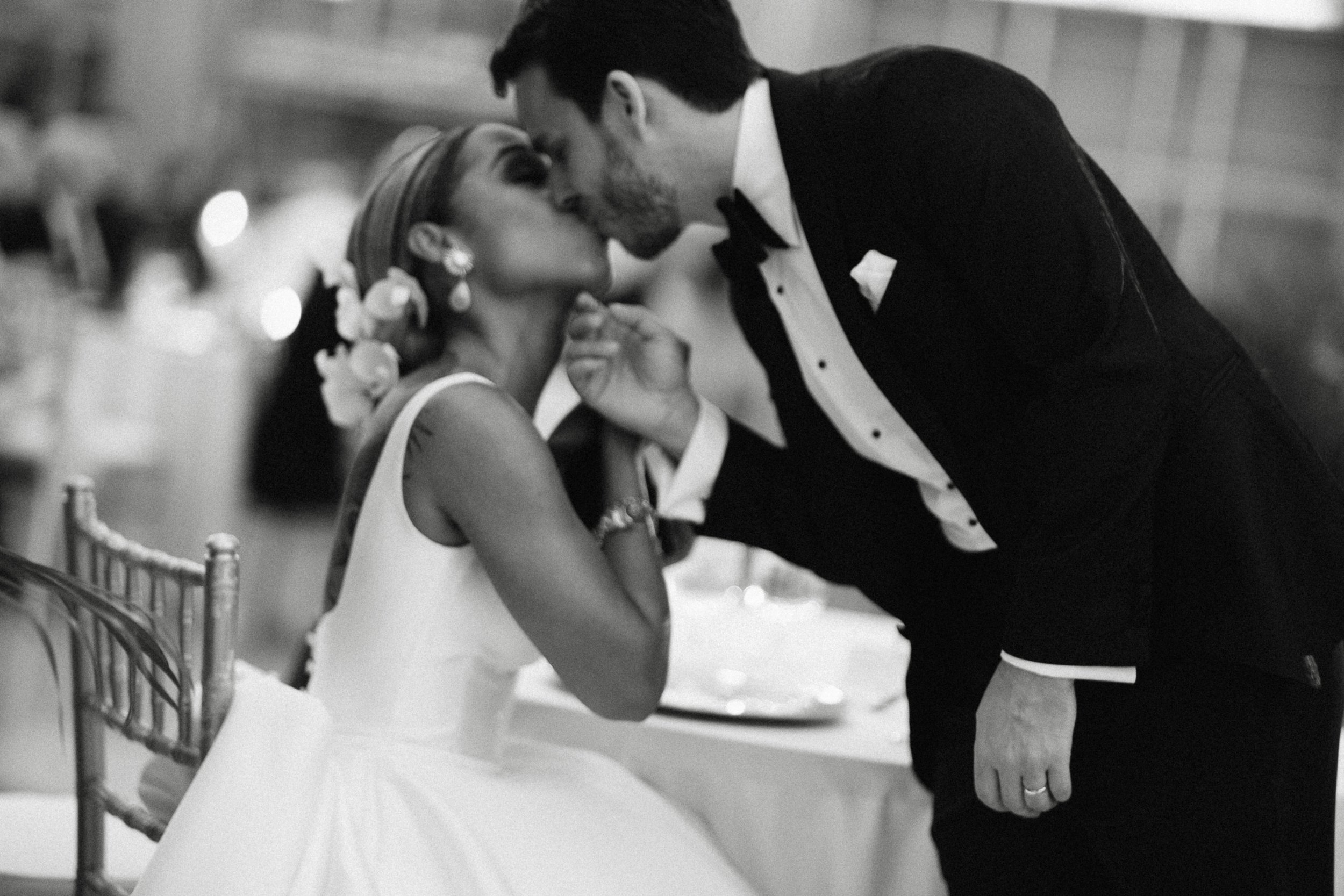 Tender kiss bride and groom reception 