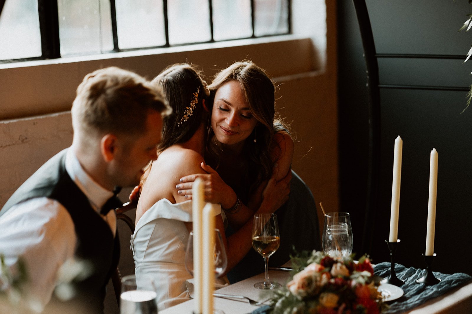 Maid of Honor sister and Bride Hugs Skeleton Root Winery Cincinnati 