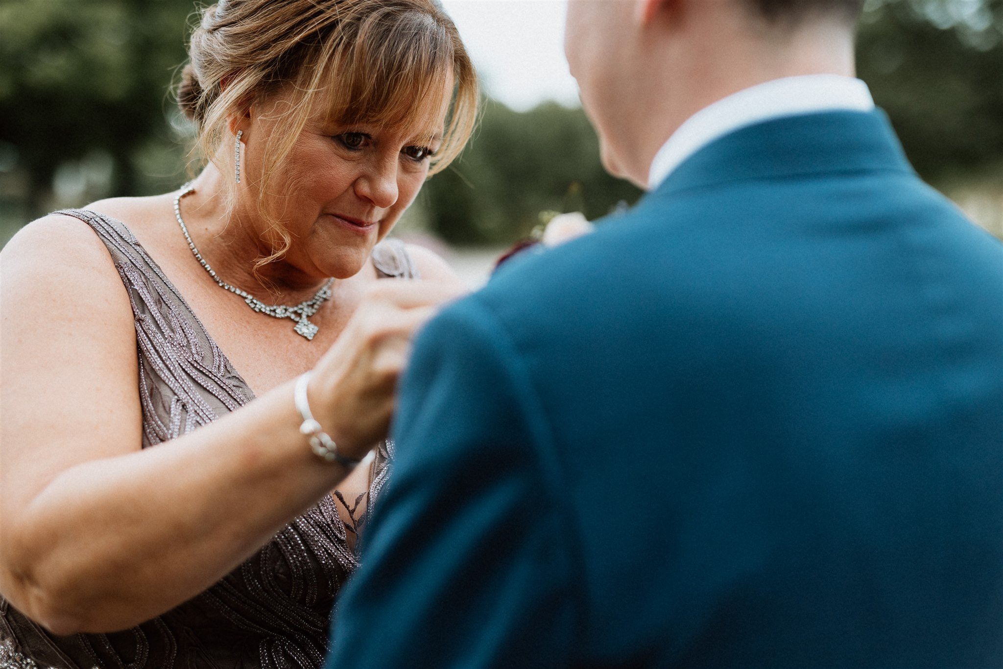 mom pinning boutonniere 