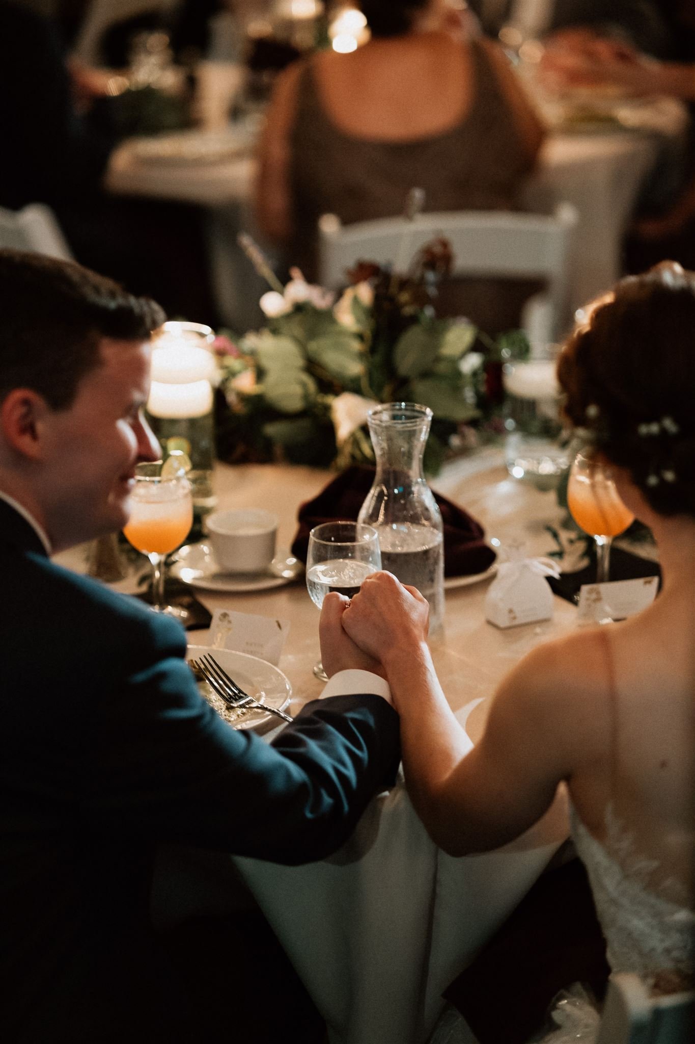 bride and groom holding hands