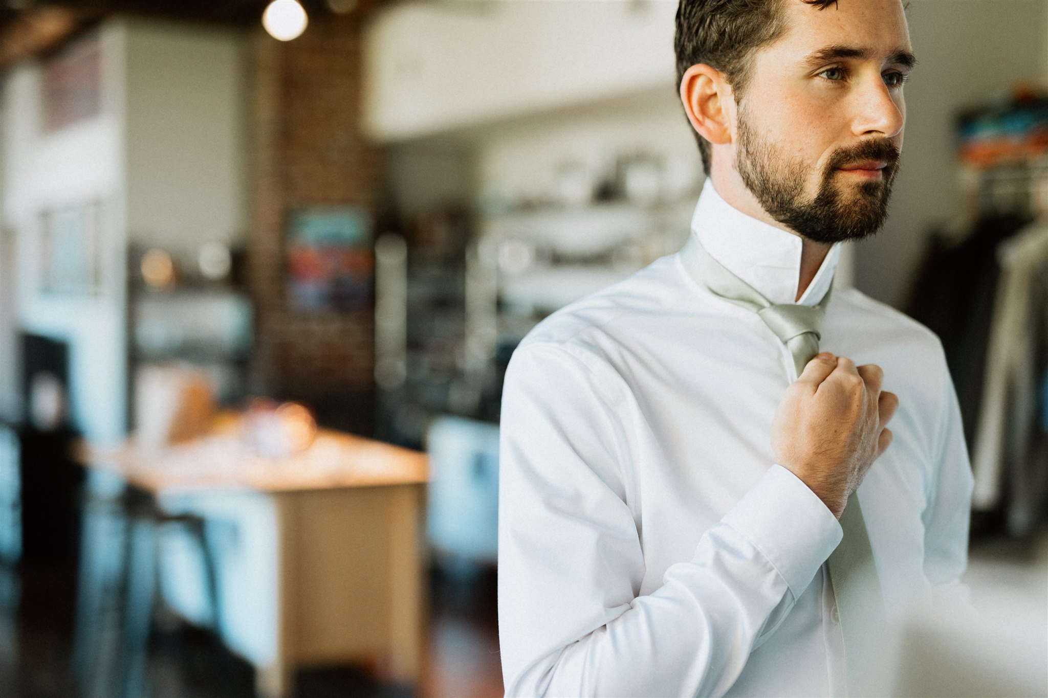 Groom tying tie