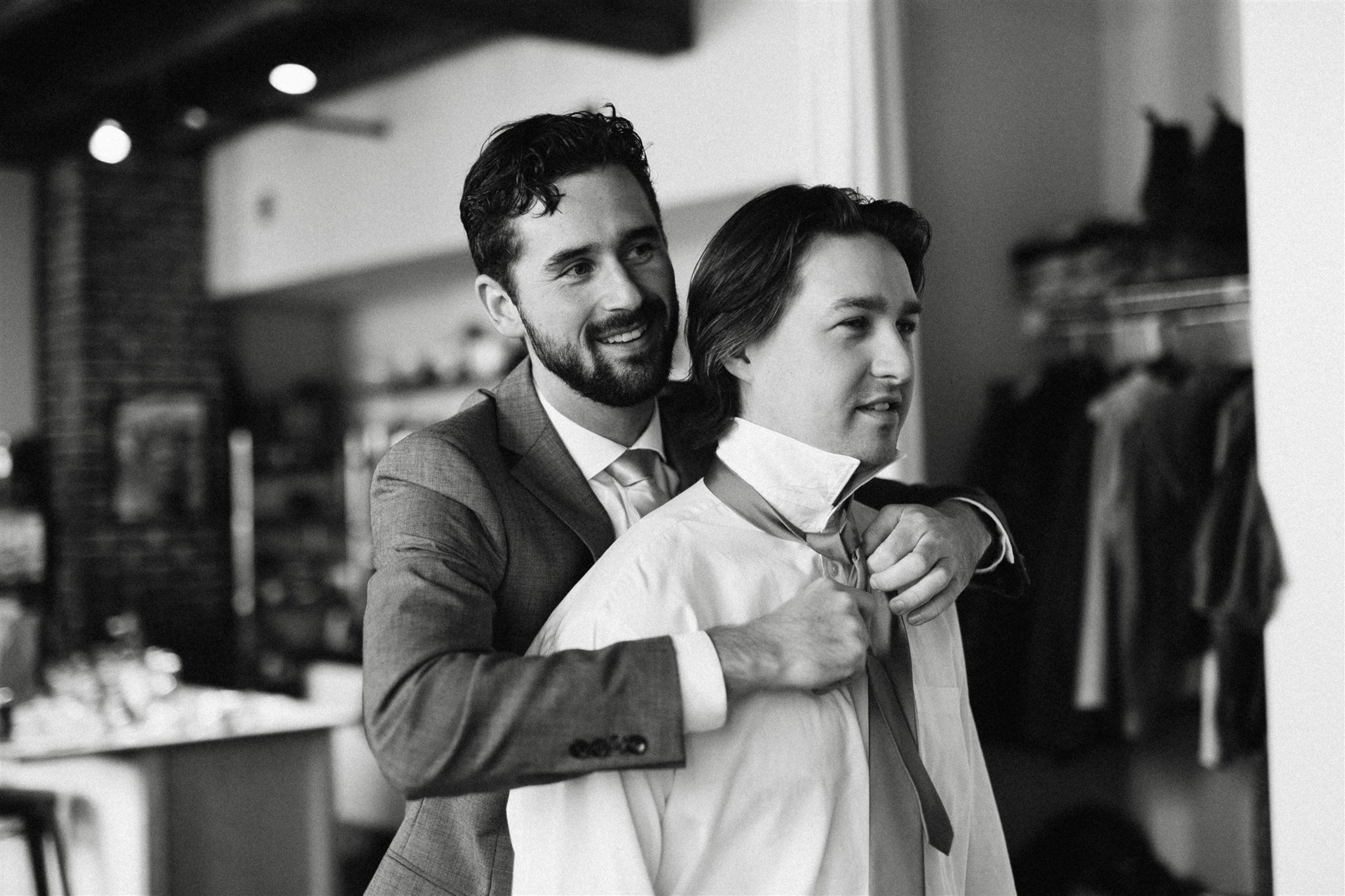 Groom helping groomsman