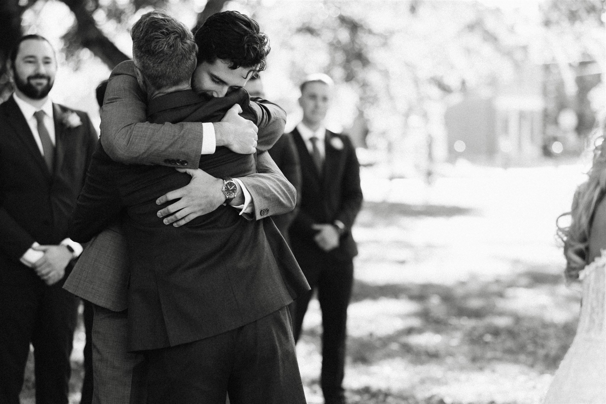 groom hugging dad