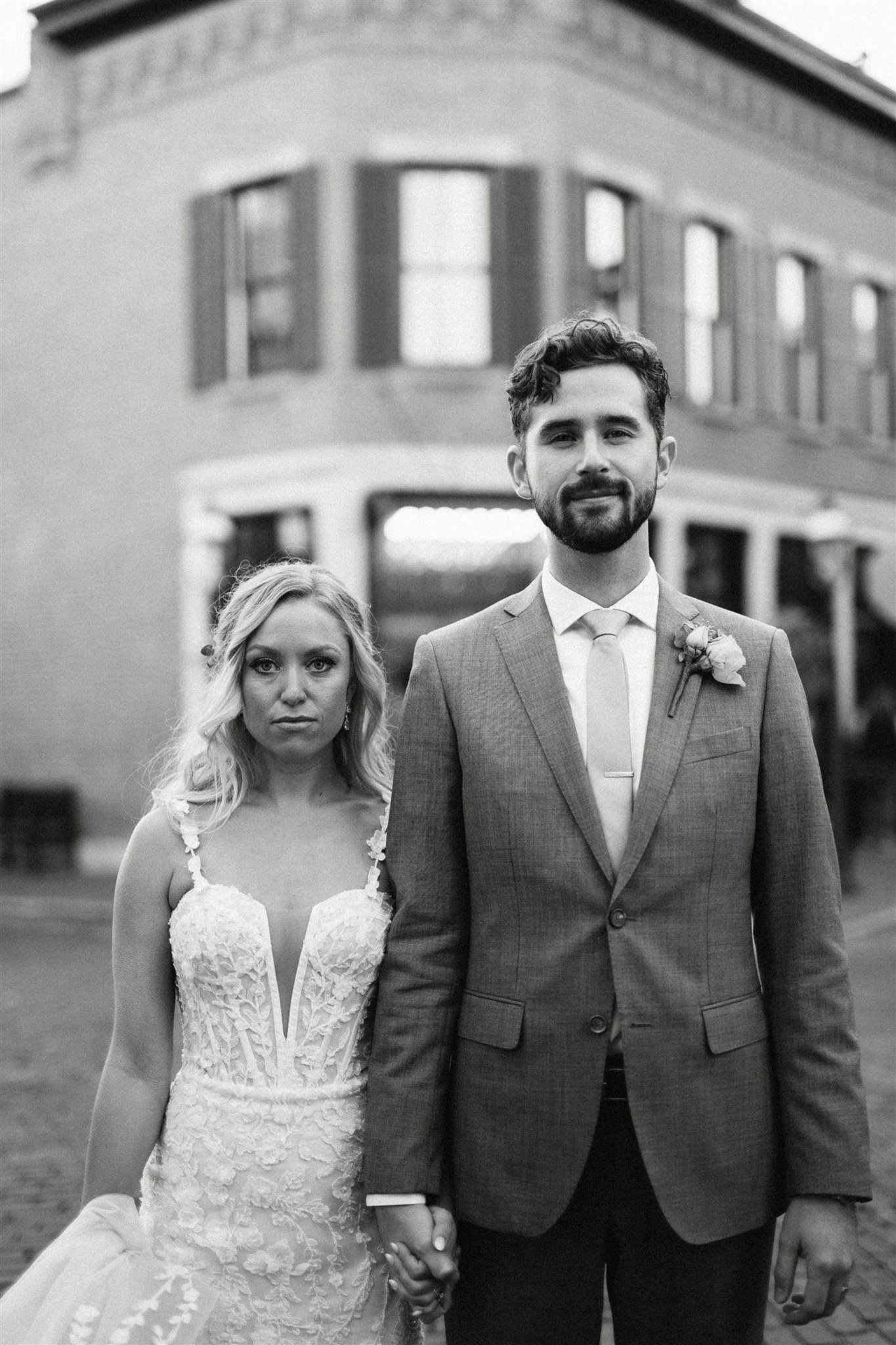 bride and groom straight faced 