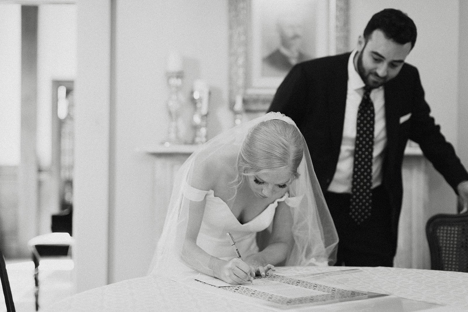 bride and groom signing ketubah