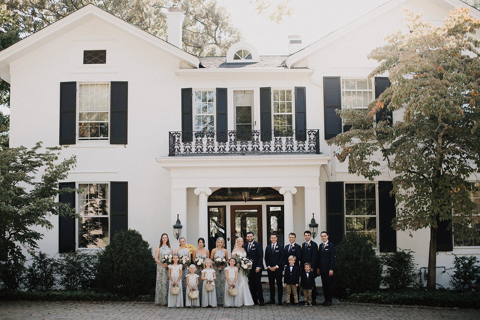 wedding party in front of home