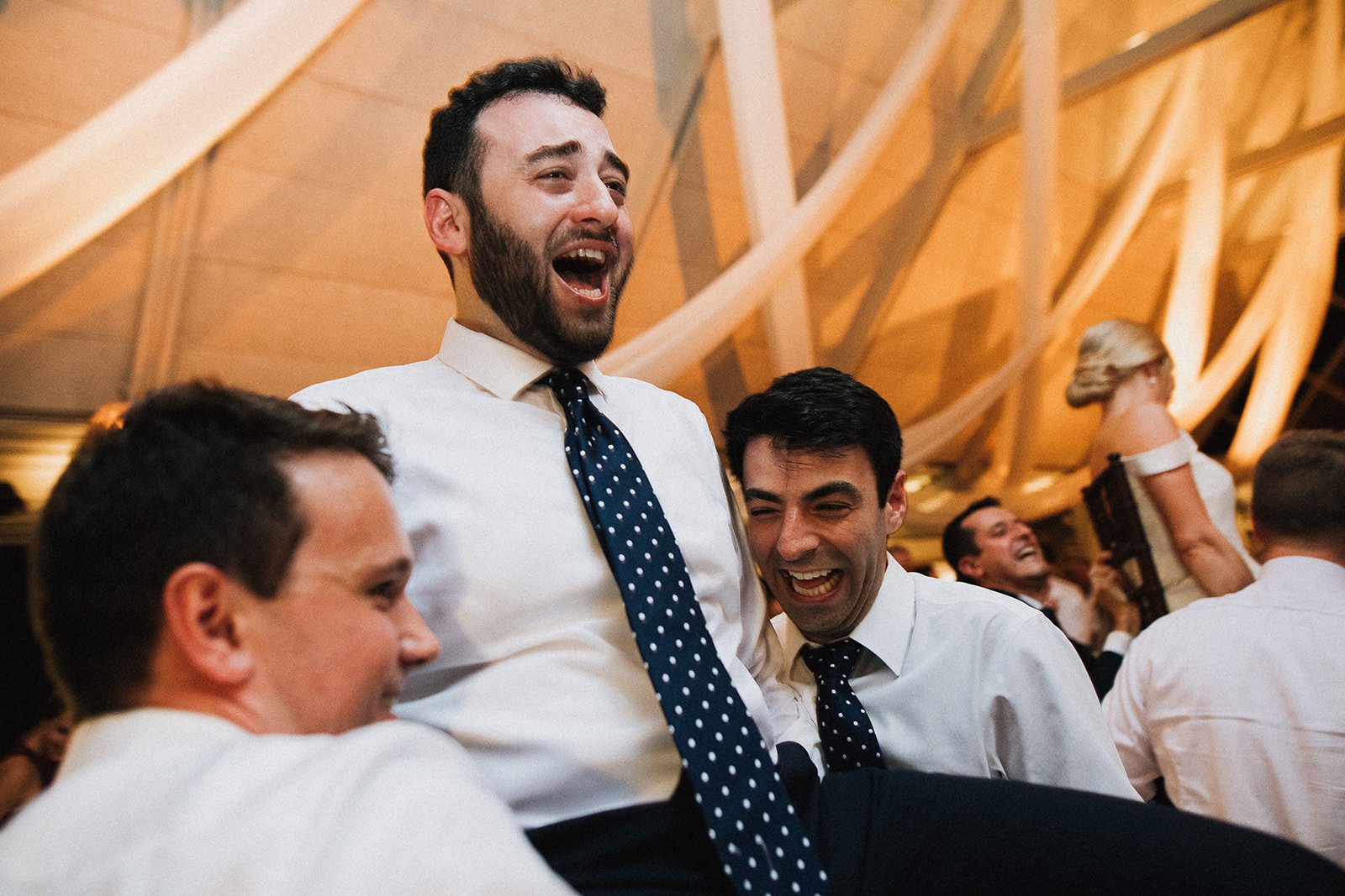 groom on chair during horah