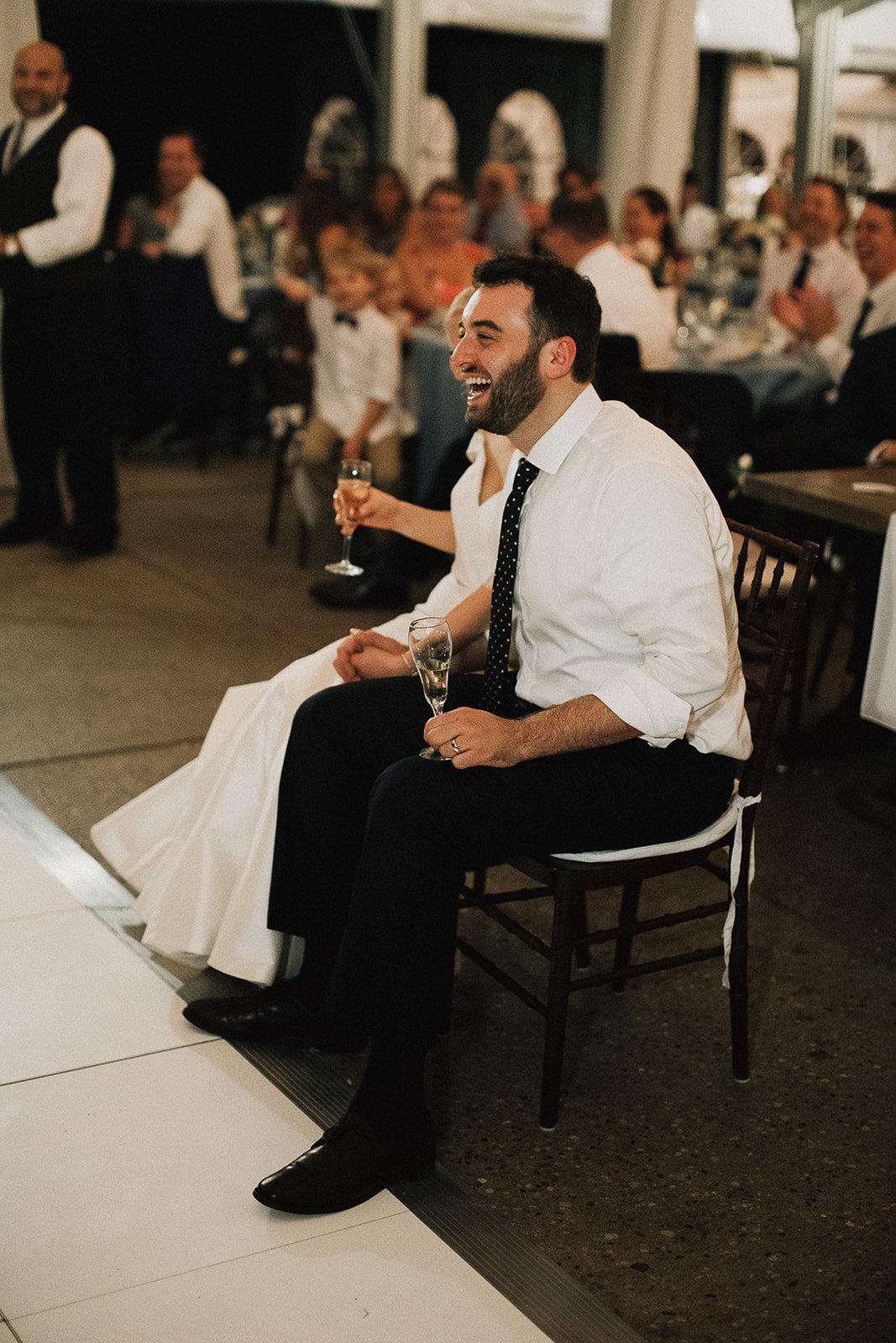 groom laughing reaction to toast