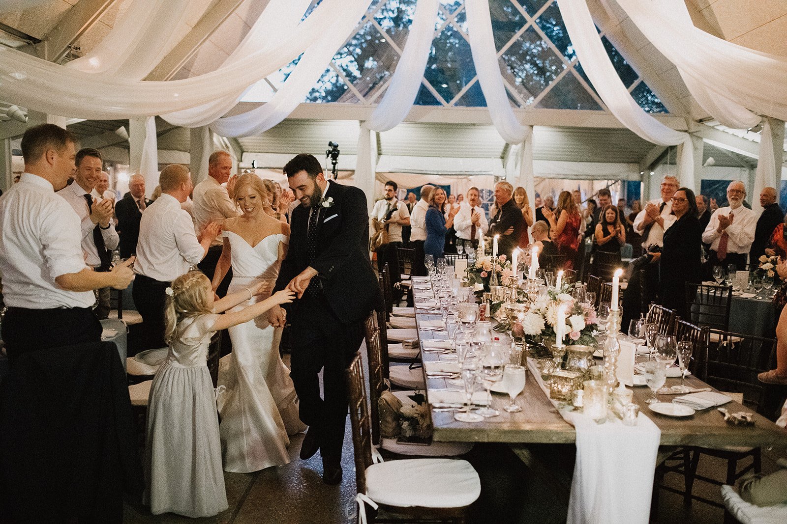 Bride and groom entering wedding reception at Camargo Club in Cincinnati 