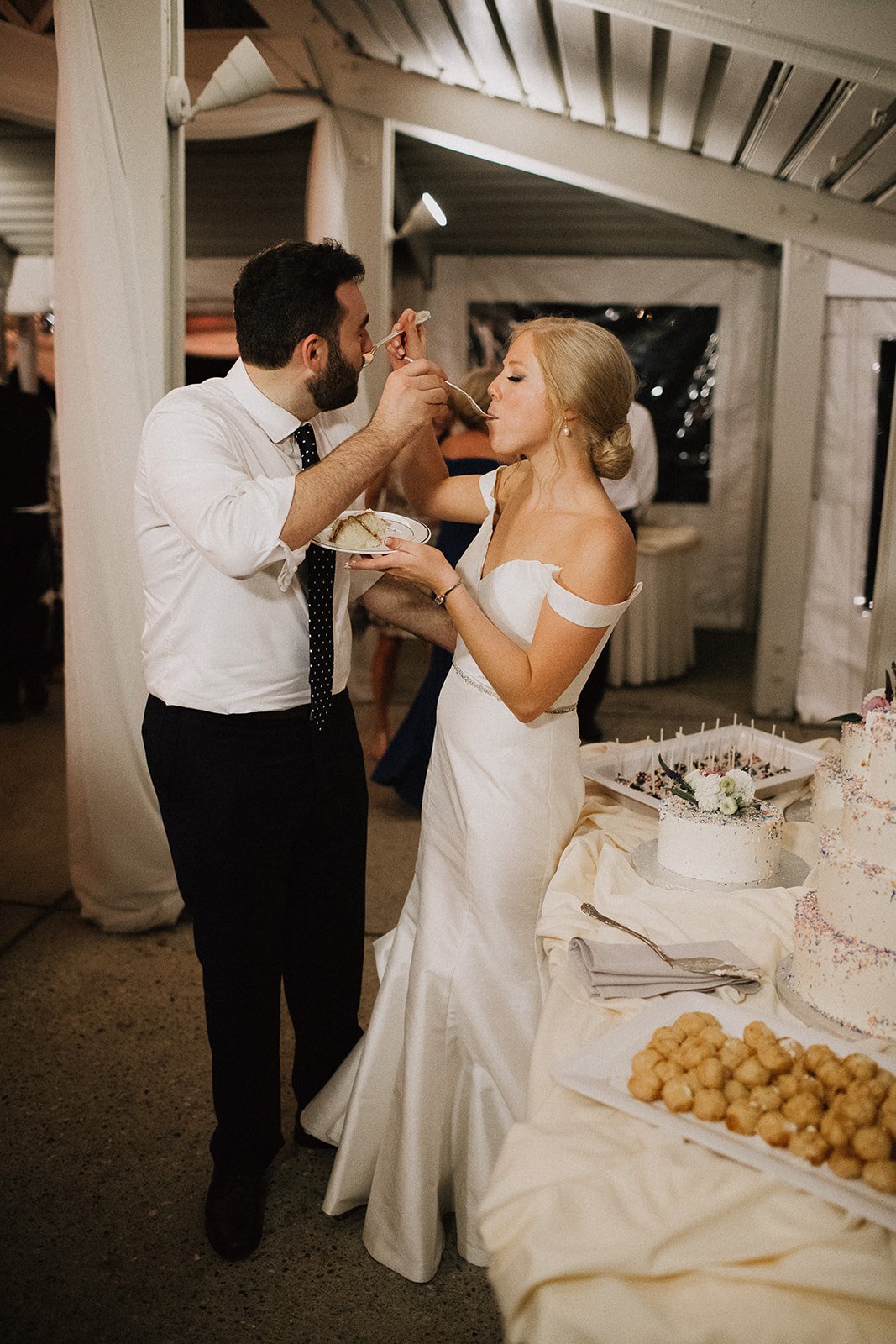 Bride and groom eating cake Camargo Club Wedding