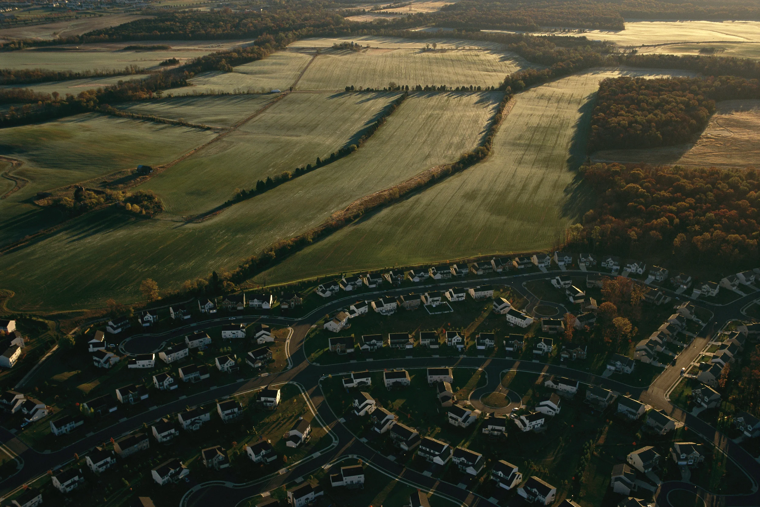 Sprawling subdivision is quickly replacing farms and natural lands with paved surface collect pollution which is carried into streams by runoff.