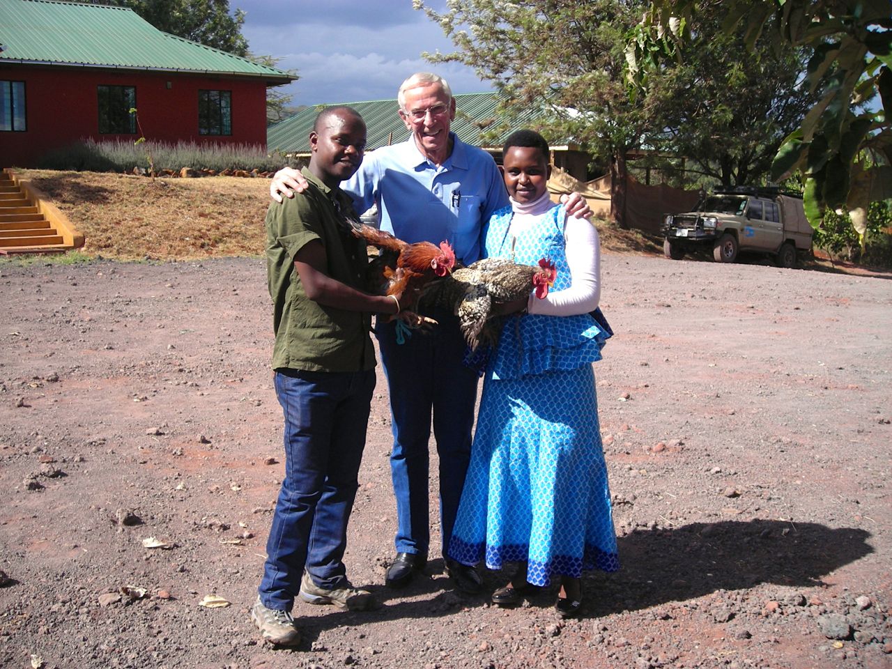 Martina and her husband gift Dr. Duane with two chickens